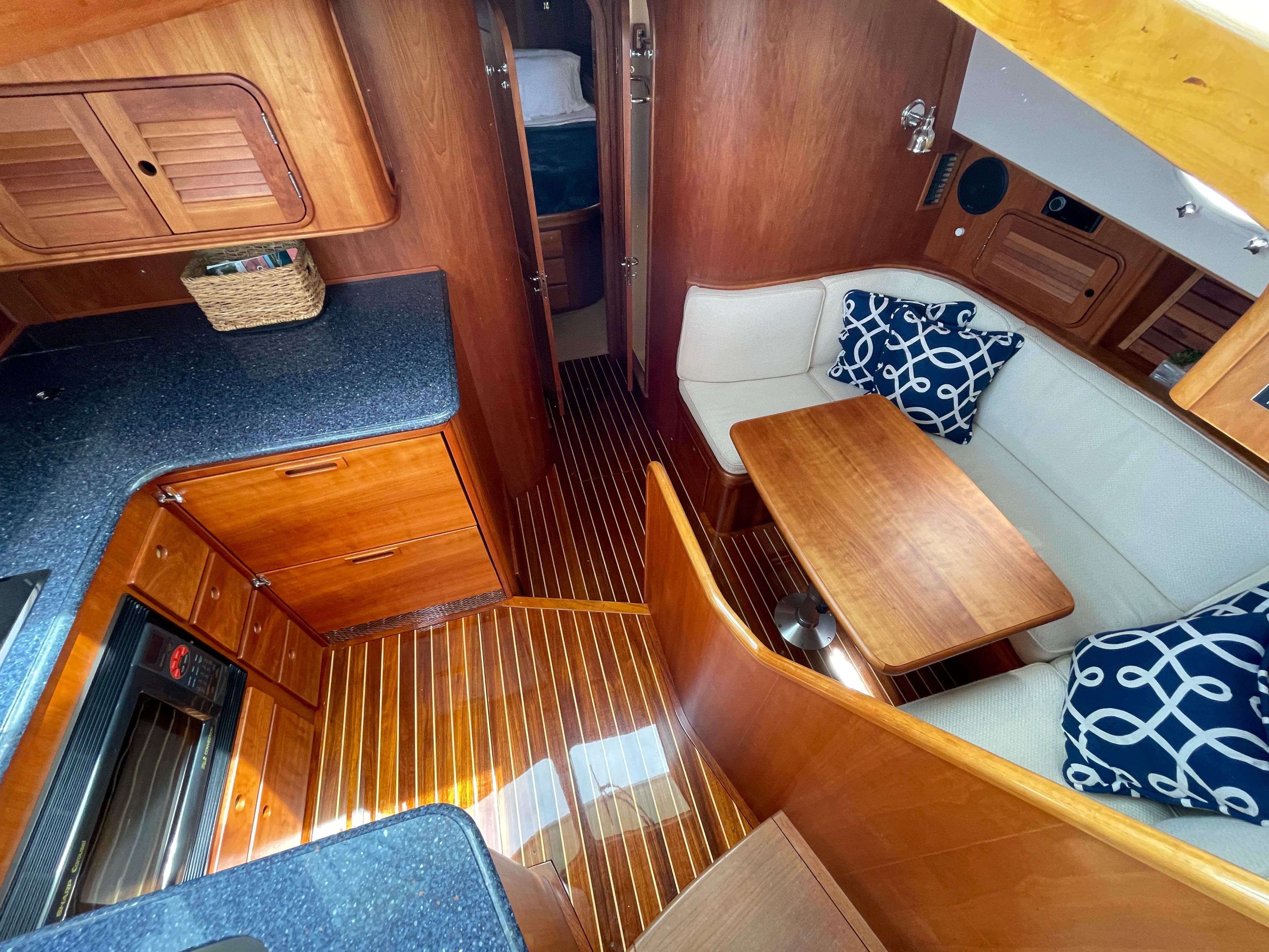 Luxurious 2007 Hinckley Talaria 44 Flybridge interior with elegant wood finish and cozy seating.