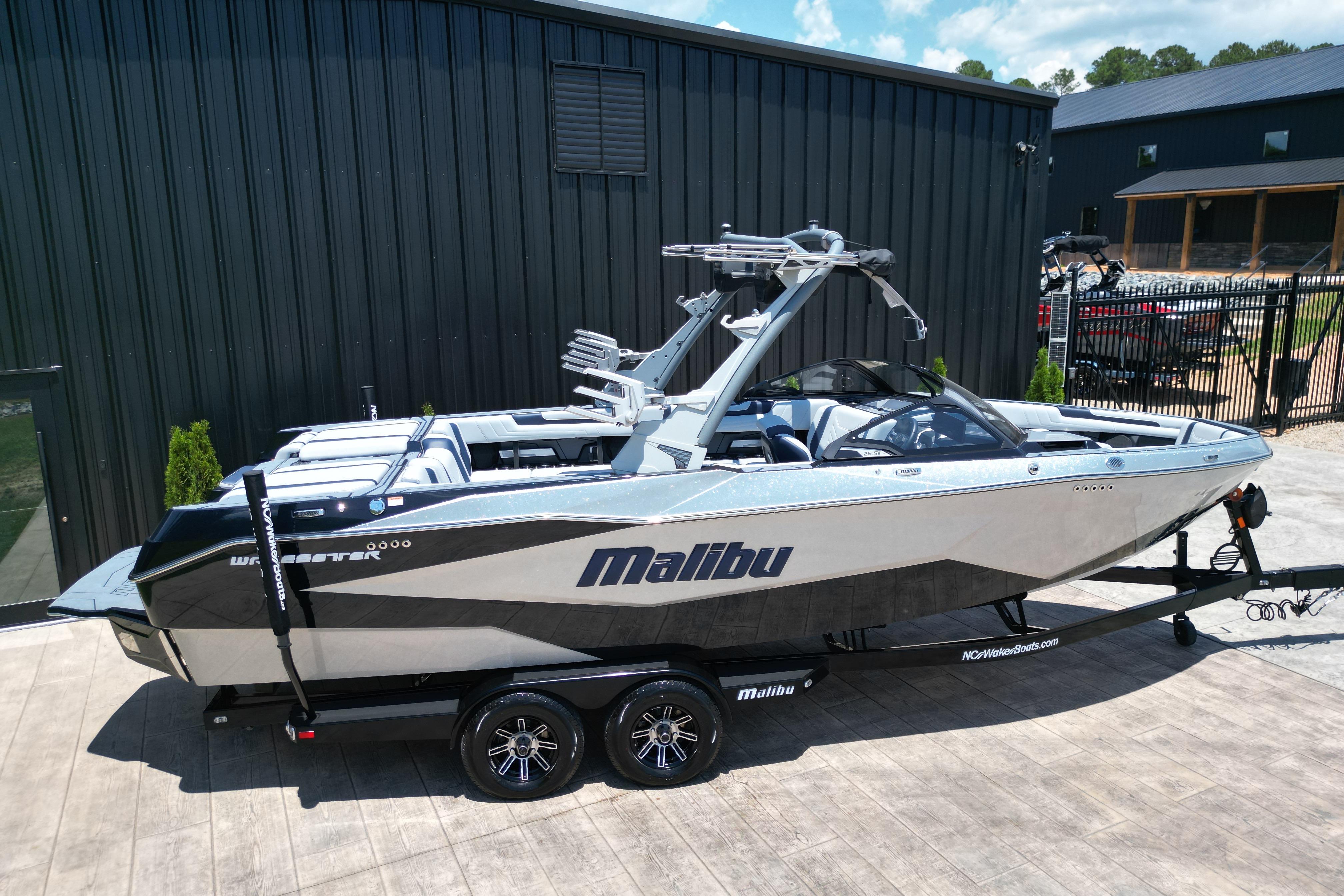 2025 Malibu Wakesetter 25 LSV boat on trailer, parked outdoors.