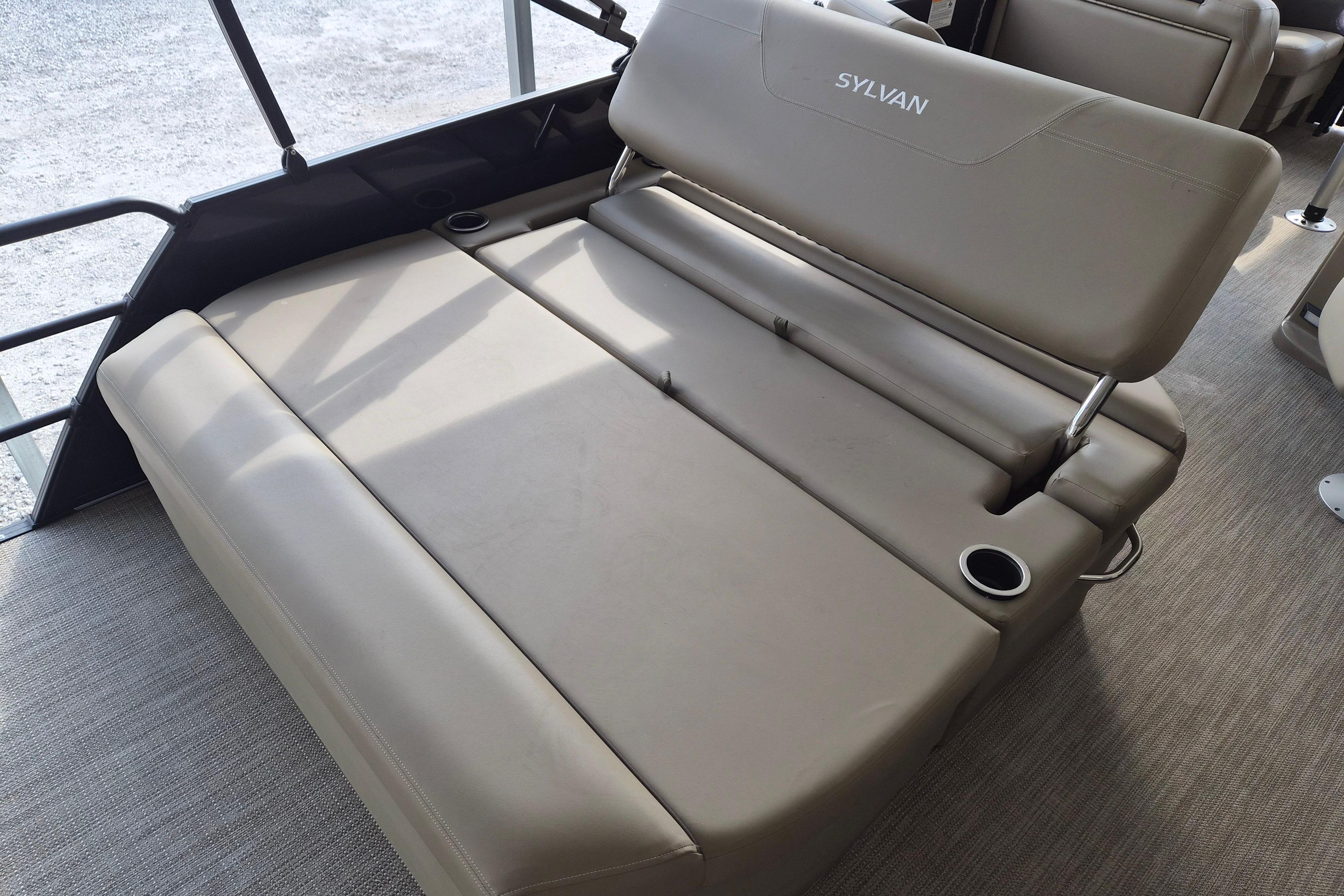 2026 Sylvan Mirage 820 CLZ DH boat interior with beige seating and cup holders.