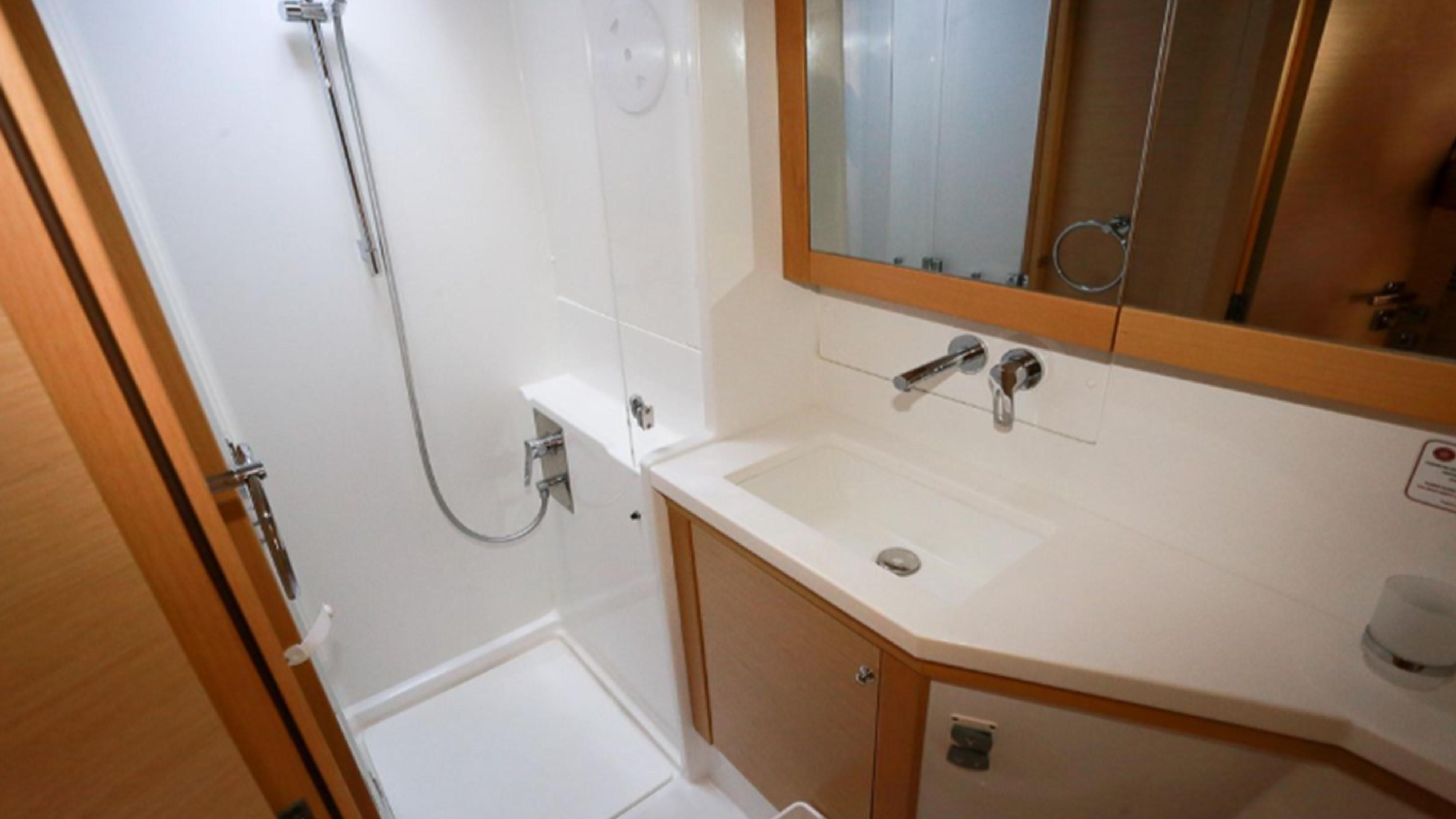 Bathroom interior of 2017 Lagoon 450 F yacht, featuring shower and sink.
