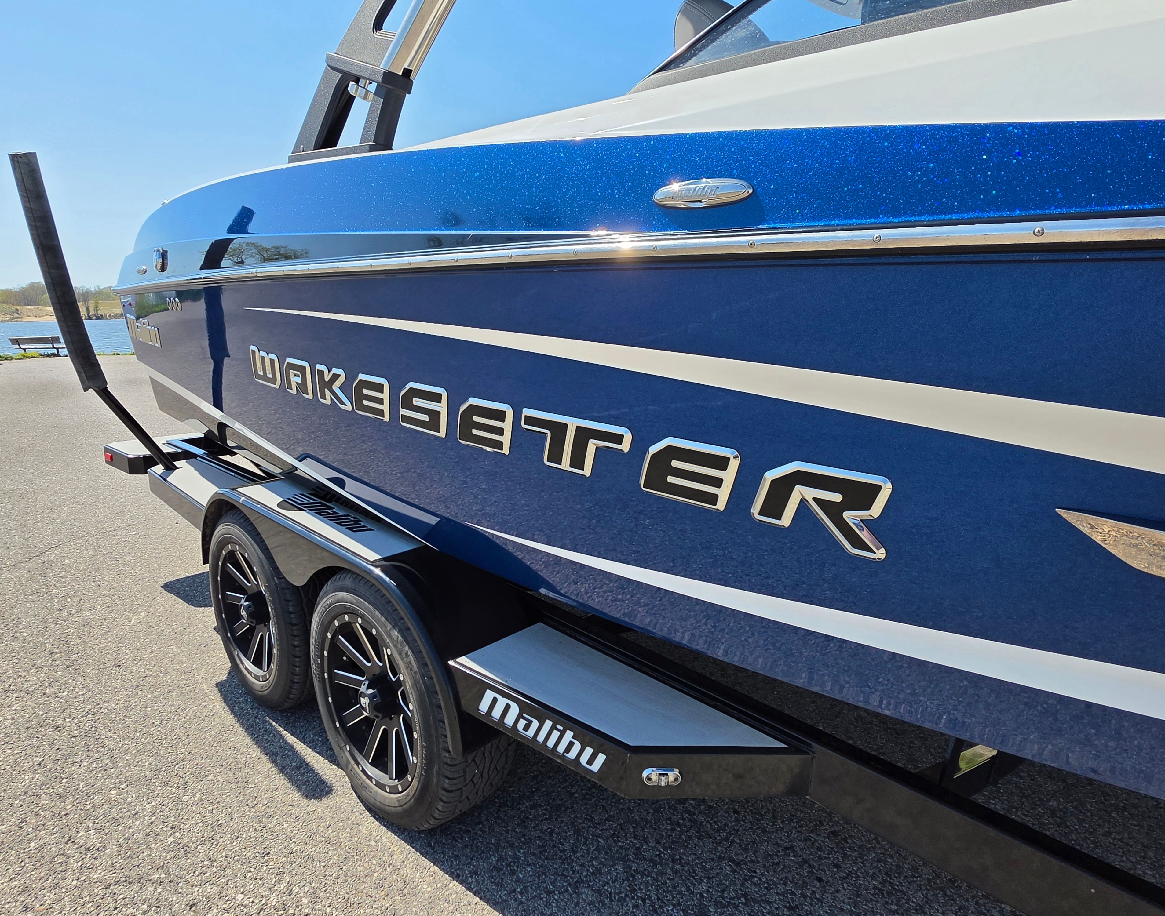 2014 Malibu Wakesetter 24 MXZ boat on trailer, blue color.
