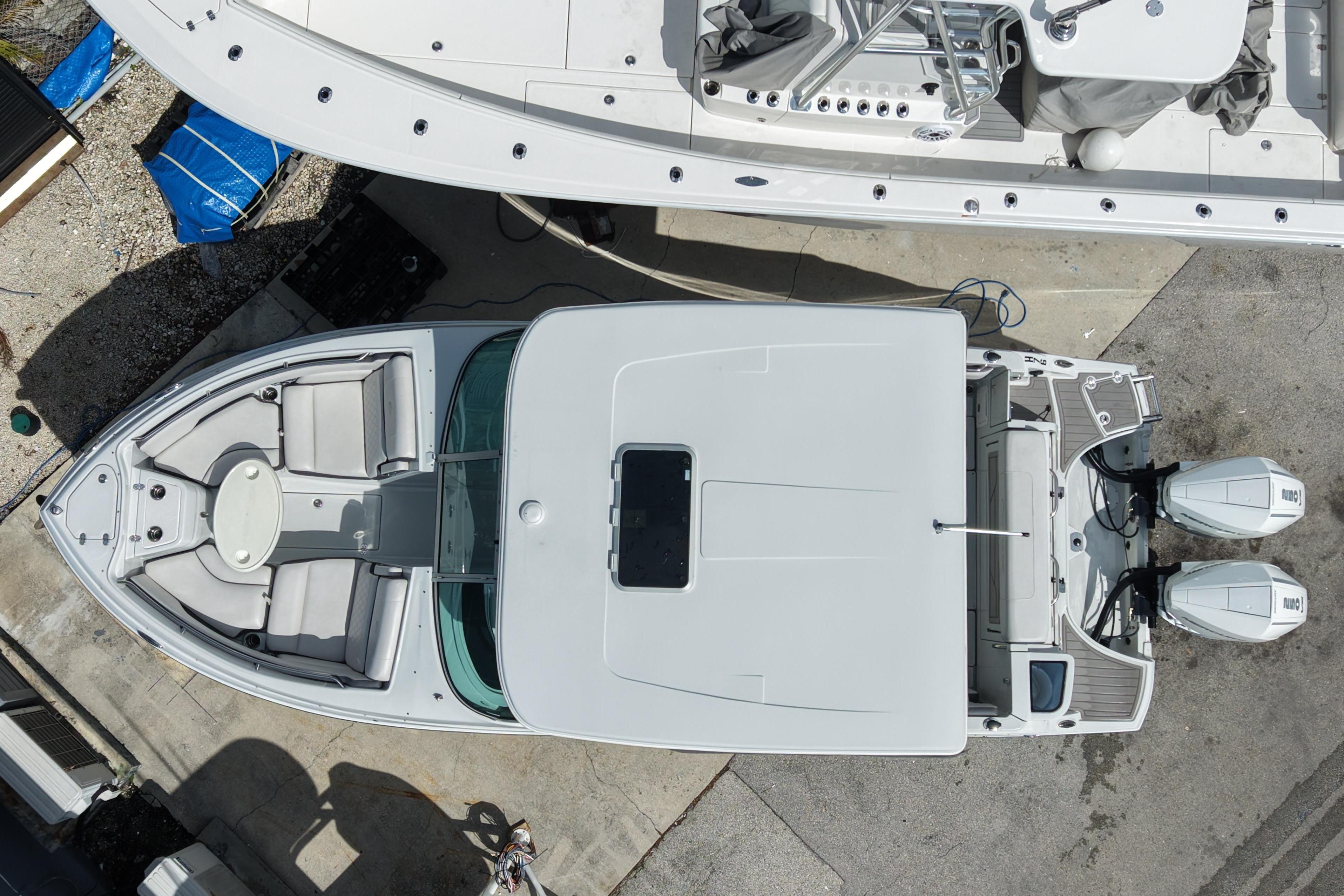 Overhead view of 2024 Crownline 260 DC Finseeker boat docked, showcasing spacious deck and dual engines.