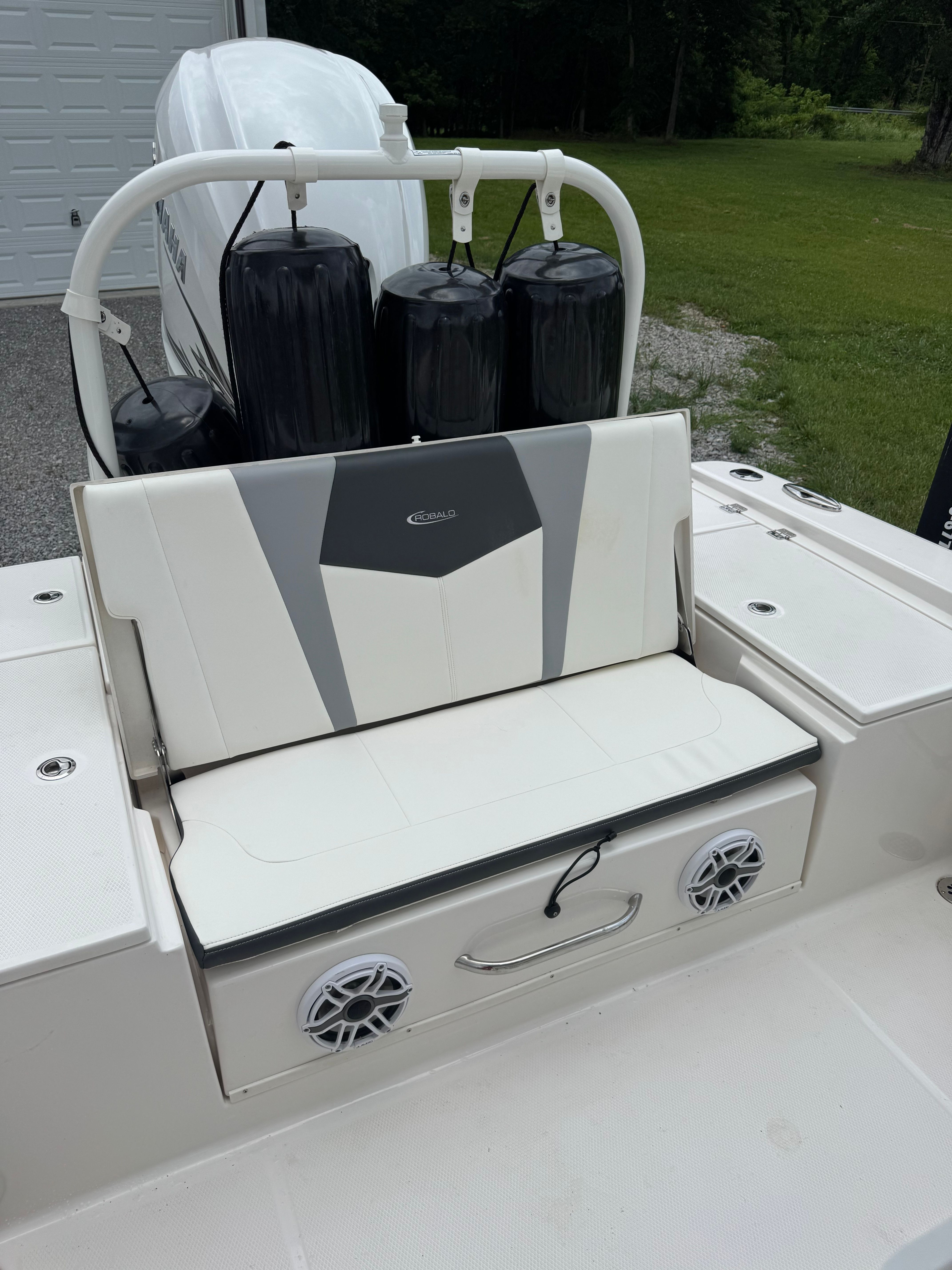 The image shows the seating area of a 2023 Robalo 266 Cayman boat with speakers.