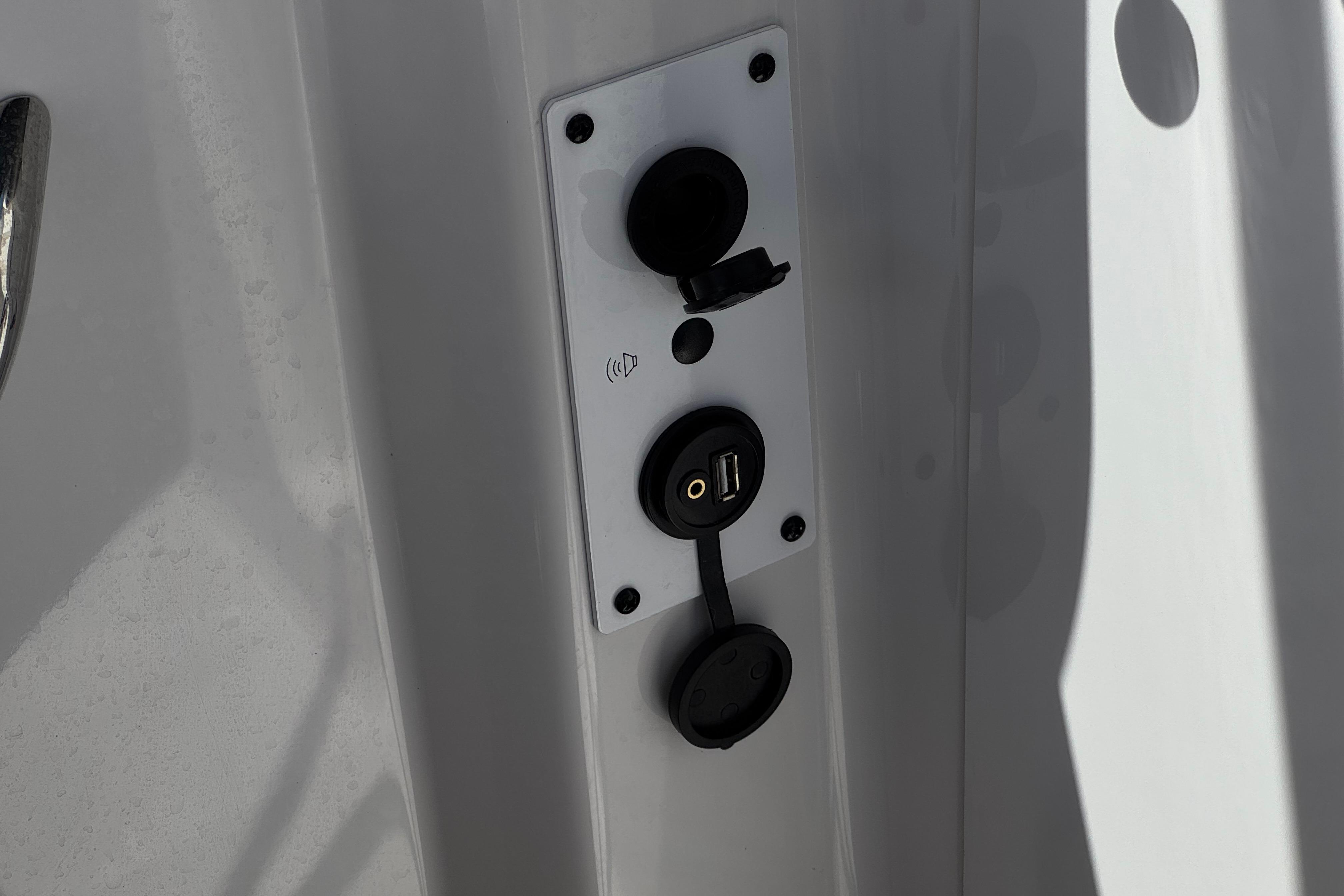 USB and audio ports on 2017 Scarab 255 H.O. Platinum boat panel.