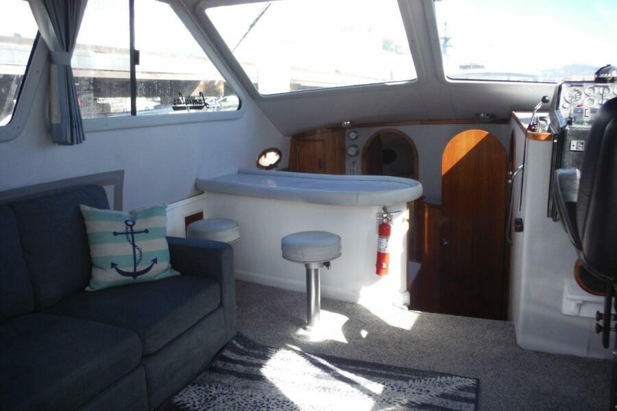 Interior of a 1990 Mediterranean Sport Fish boat with seating and helm.