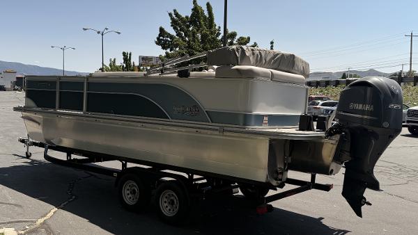 2023 SunCatcher Select 322FC pontoon boat on trailer with Yamaha outboard motor.