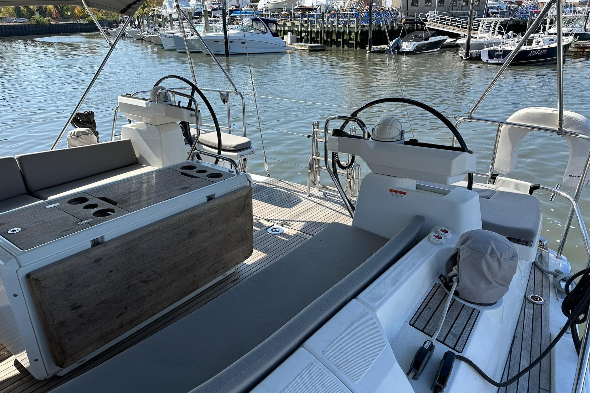 Cockpit view of a 2018 Jeanneau 51 yacht docked at a marina.