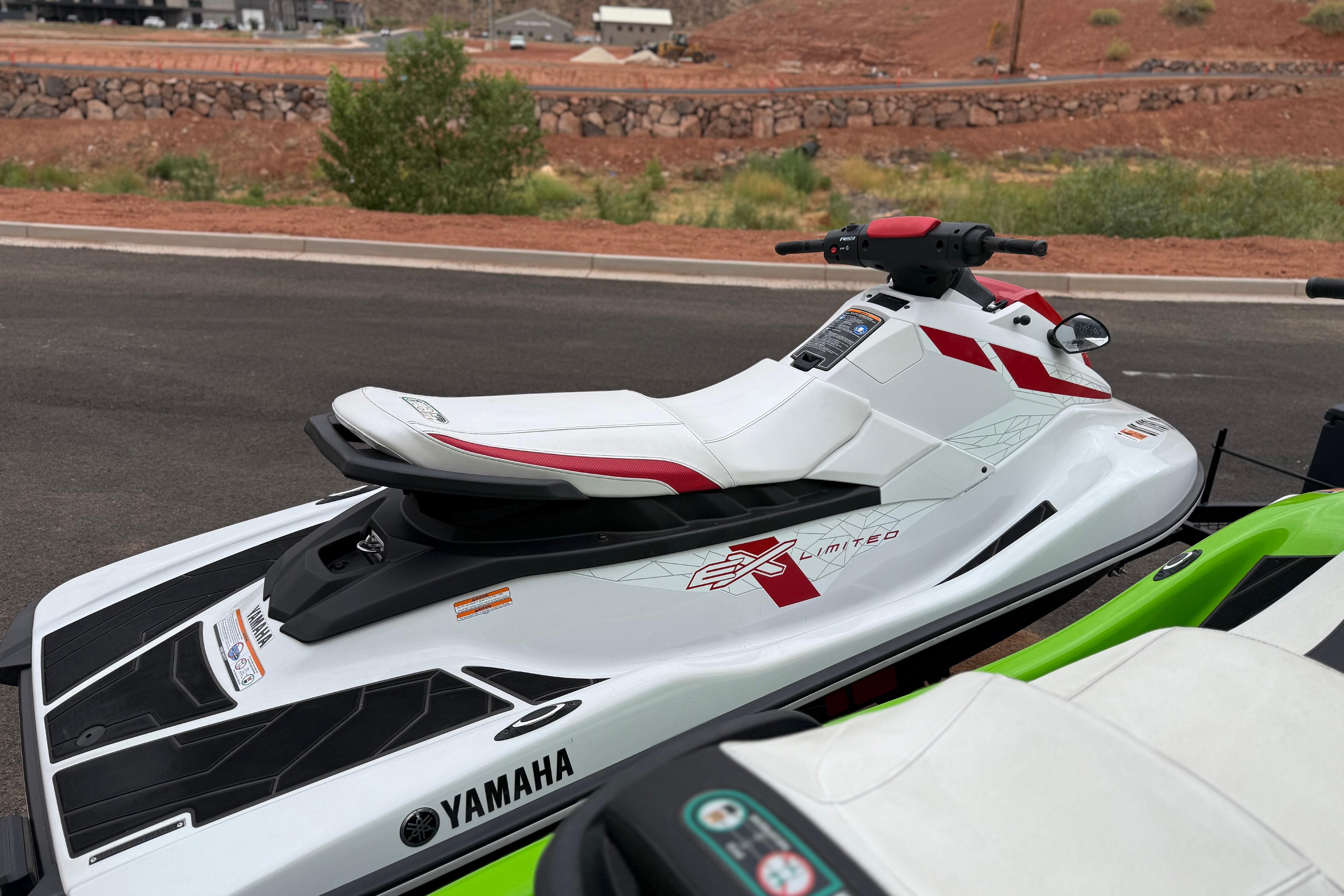 2021 Yamaha WaveRunner EX Limited jet ski, white with red accents, parked outdoors.