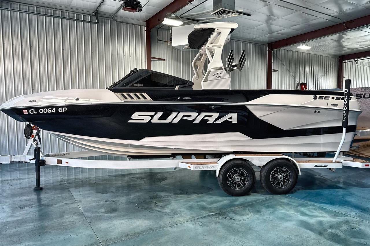 2020 Supra SE boat on trailer in indoor storage facility.