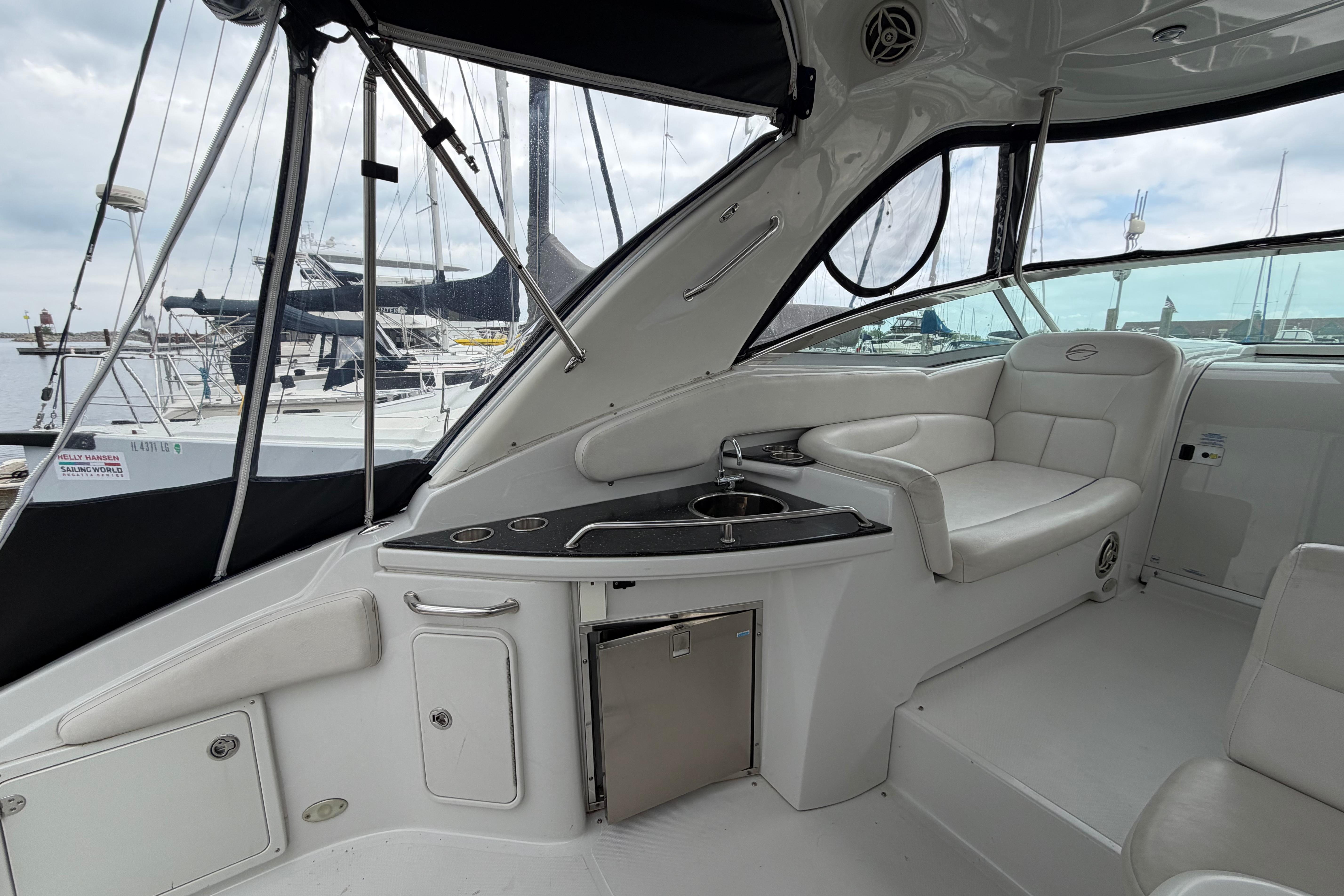 2008 Crownline 340 CR yacht interior with seating and kitchenette, docked at marina.