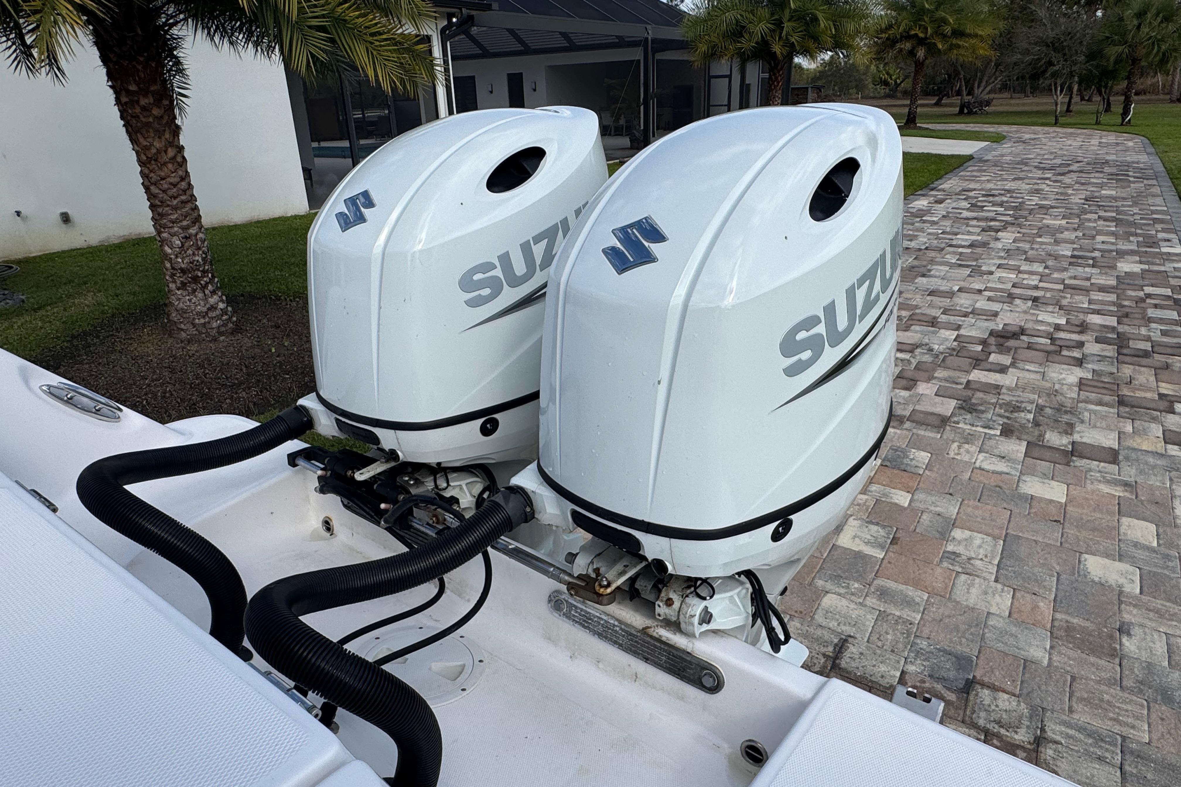 Twin Suzuki outboard engines on a 2022 Aquasport 2500 Center Console boat.