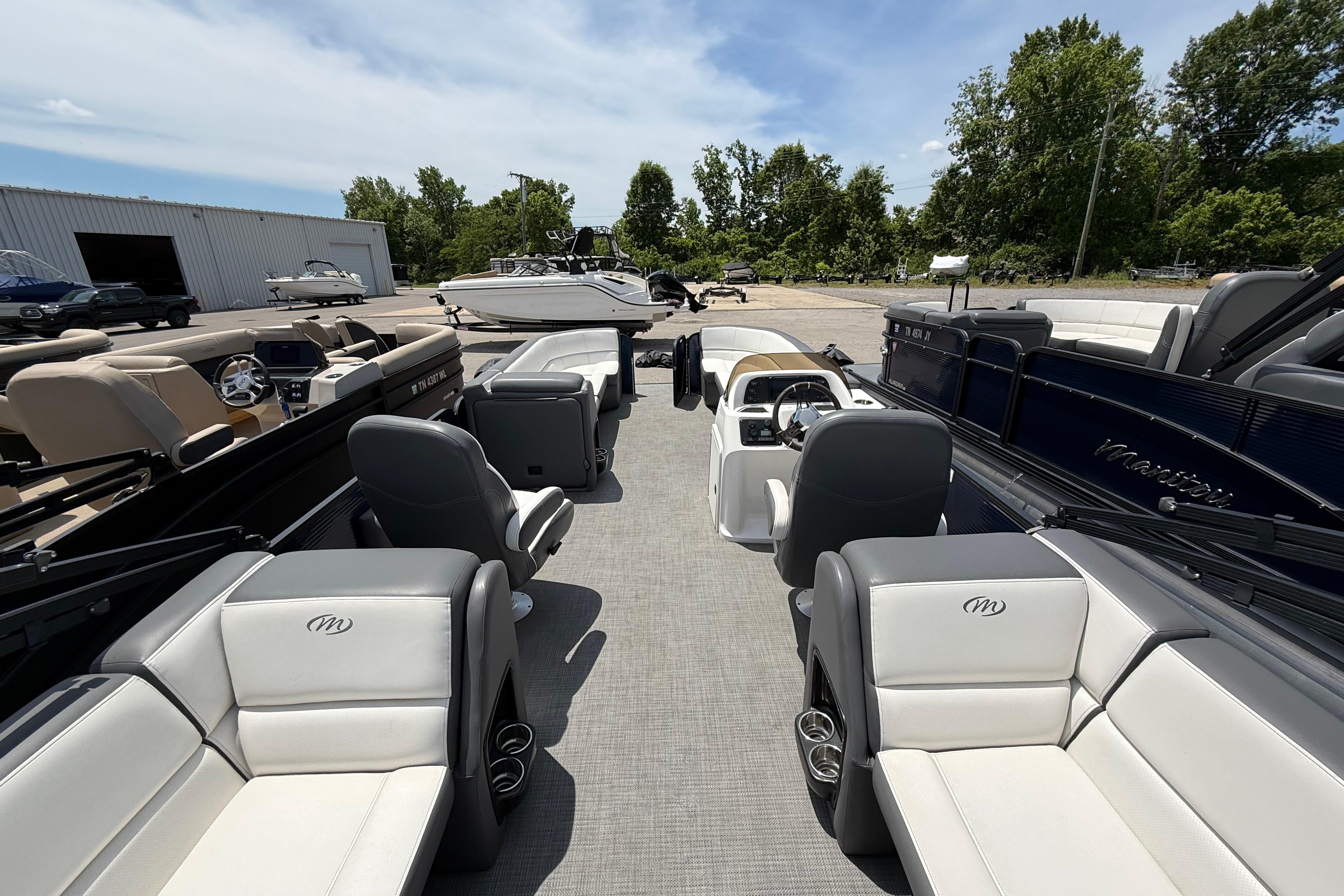 2022 Manitou Aurora LE pontoon boat with spacious seating and modern design.