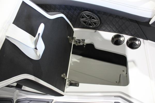 2025 Cobalt R6 boat storage compartment with cup holders and speaker.