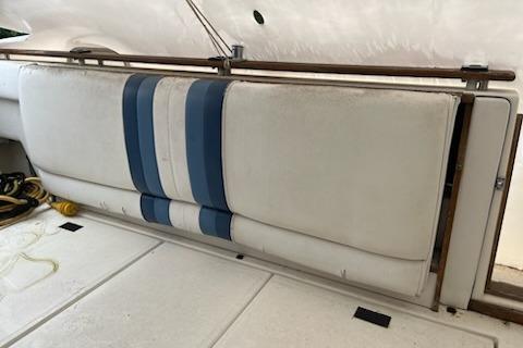 1989 Sea Ray 300 Sundancer interior with blue-striped seating and white upholstery.