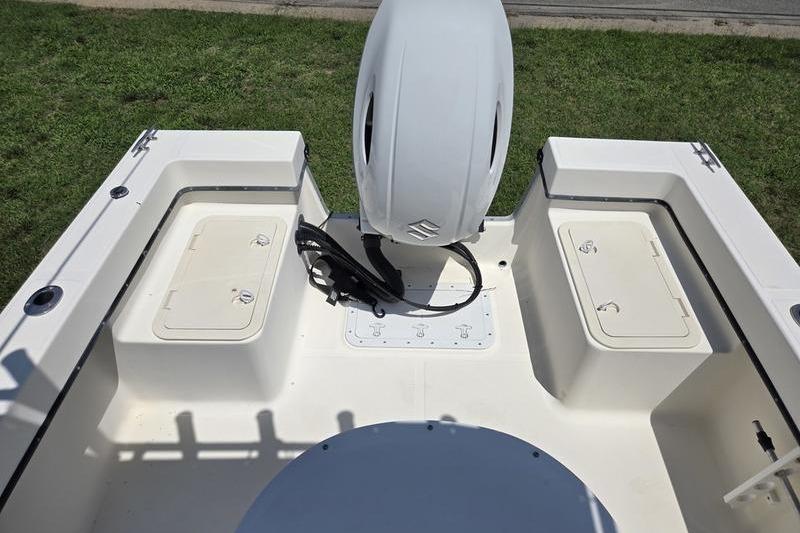 May-Craft 2000CC boat deck with storage compartments and outboard motor, year 2000 model.