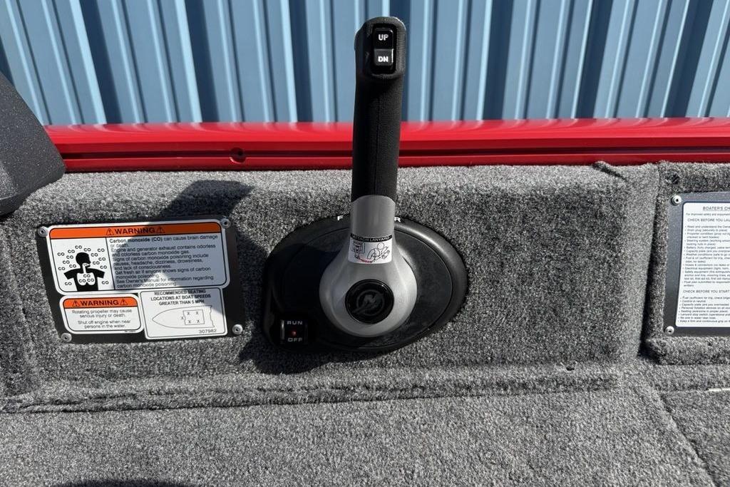 Throttle control of 2026 Tracker Pro Guide V-16 SC boat with warning labels.