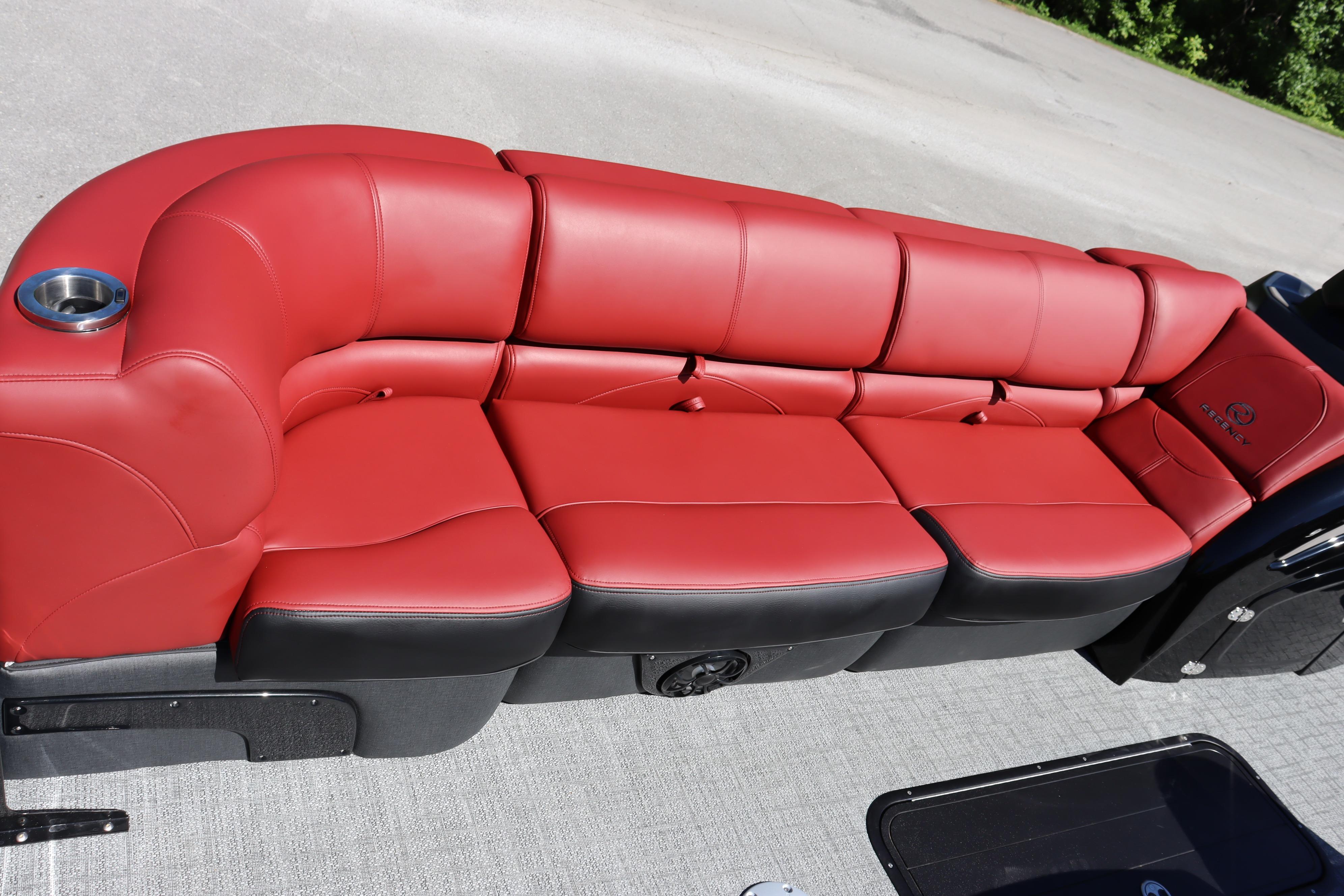 Red leather seating on 2026 Regency 250 DL boat, featuring cup holder and sleek design.