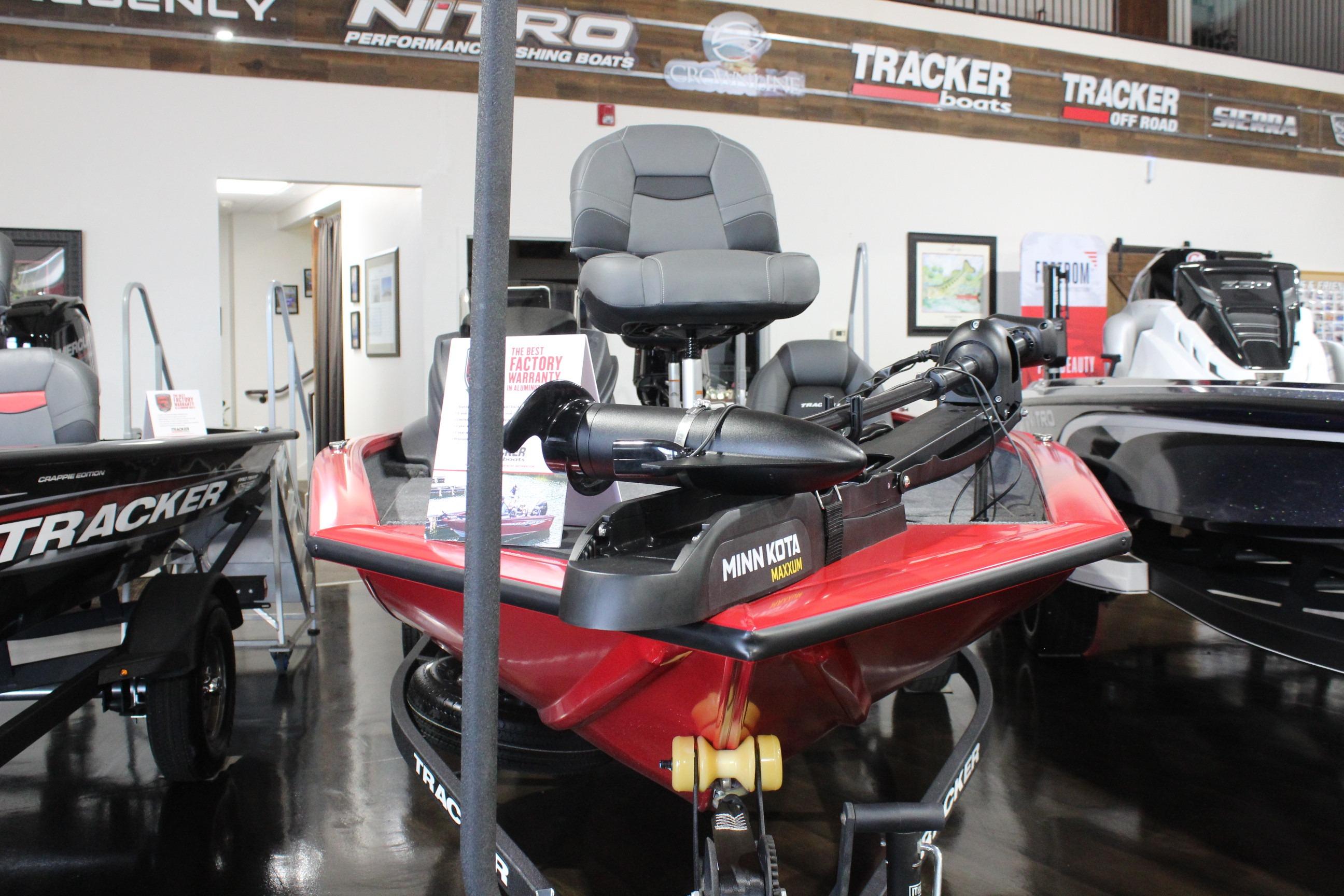 2026 Tracker Pro Team 175 boat displayed in showroom with Minn Kota trolling motor.