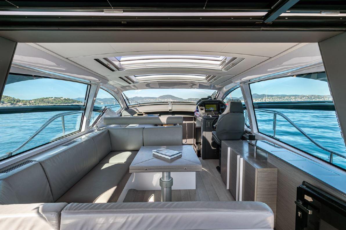 Luxurious interior of 2018 Pershing 5x yacht with panoramic windows and modern seating.