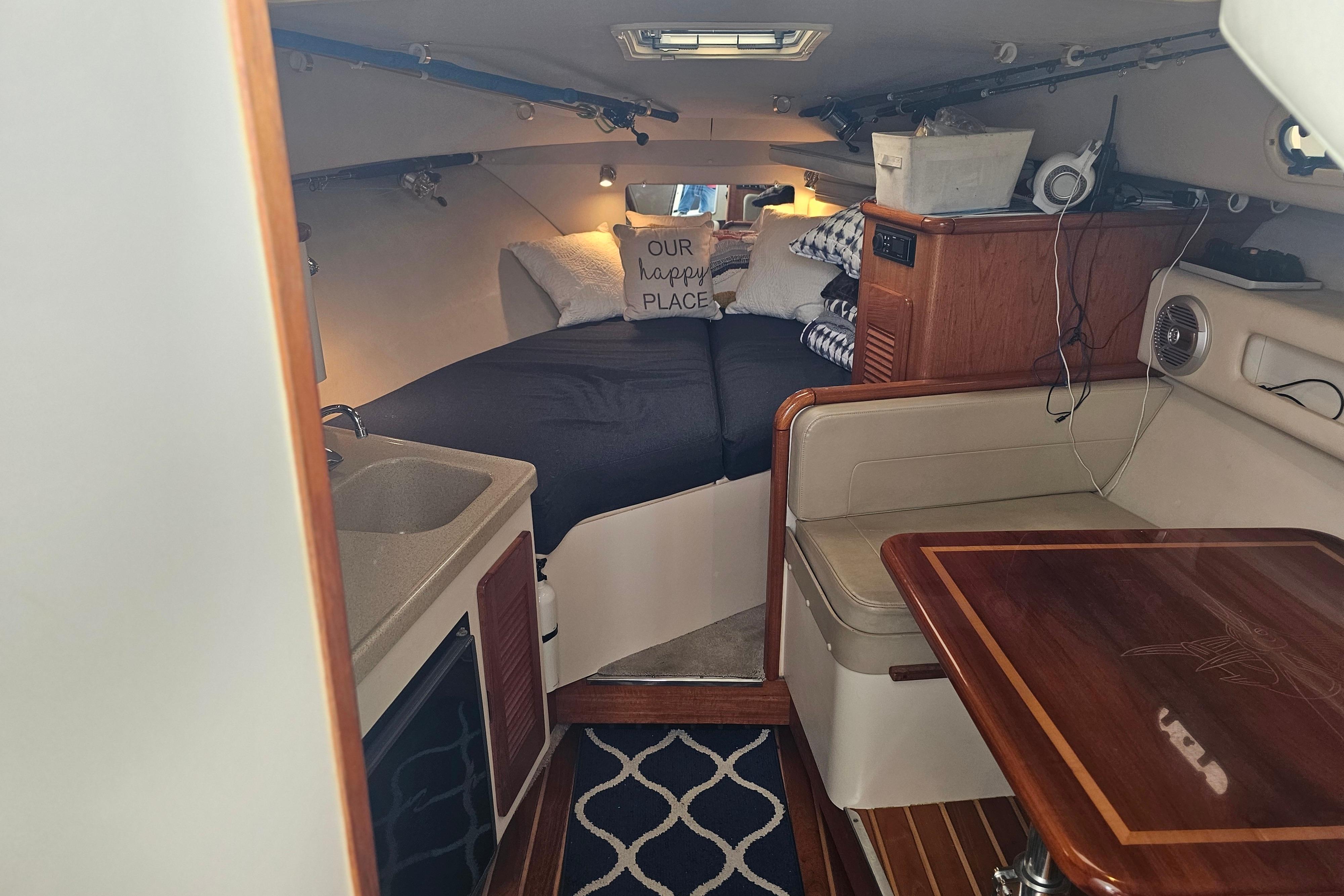 Interior of 2001 Pursuit 3000 Express boat with cozy cabin and dining area.