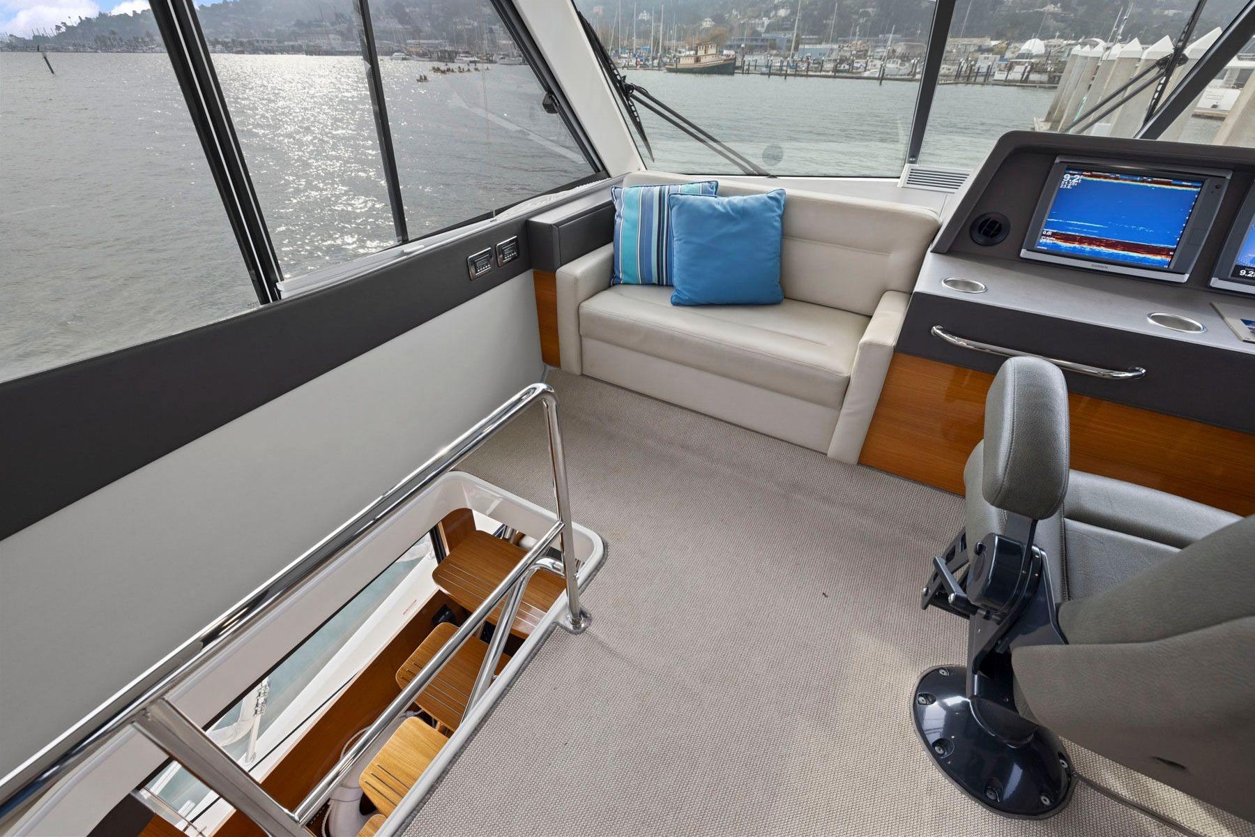 2014 Maritimo M50 yacht interior with helm, seating, and water view.