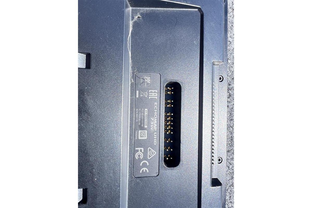 Close-up of electronic device connector with visible pins and label details.