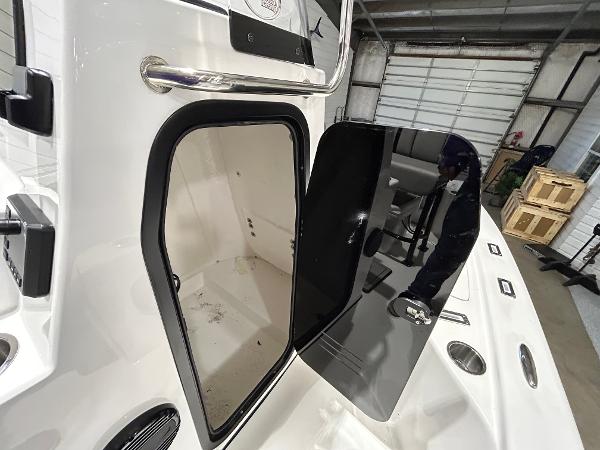 2025 Sea Pro 210 Bay boat interior with open hatch in a garage setting.