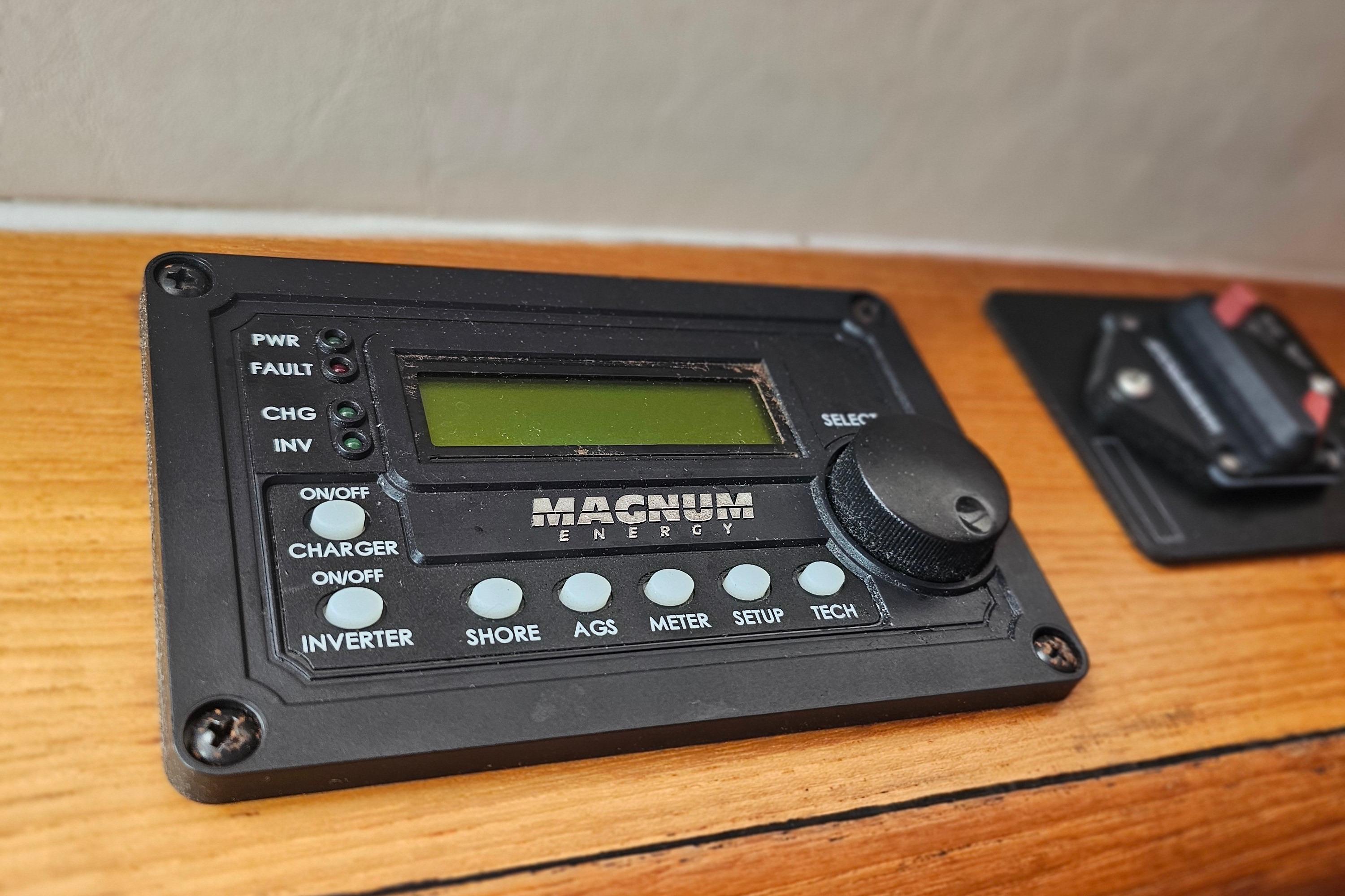 Magnum Energy control panel on 2001 Pursuit 3000 Express boat, mounted on wooden surface.