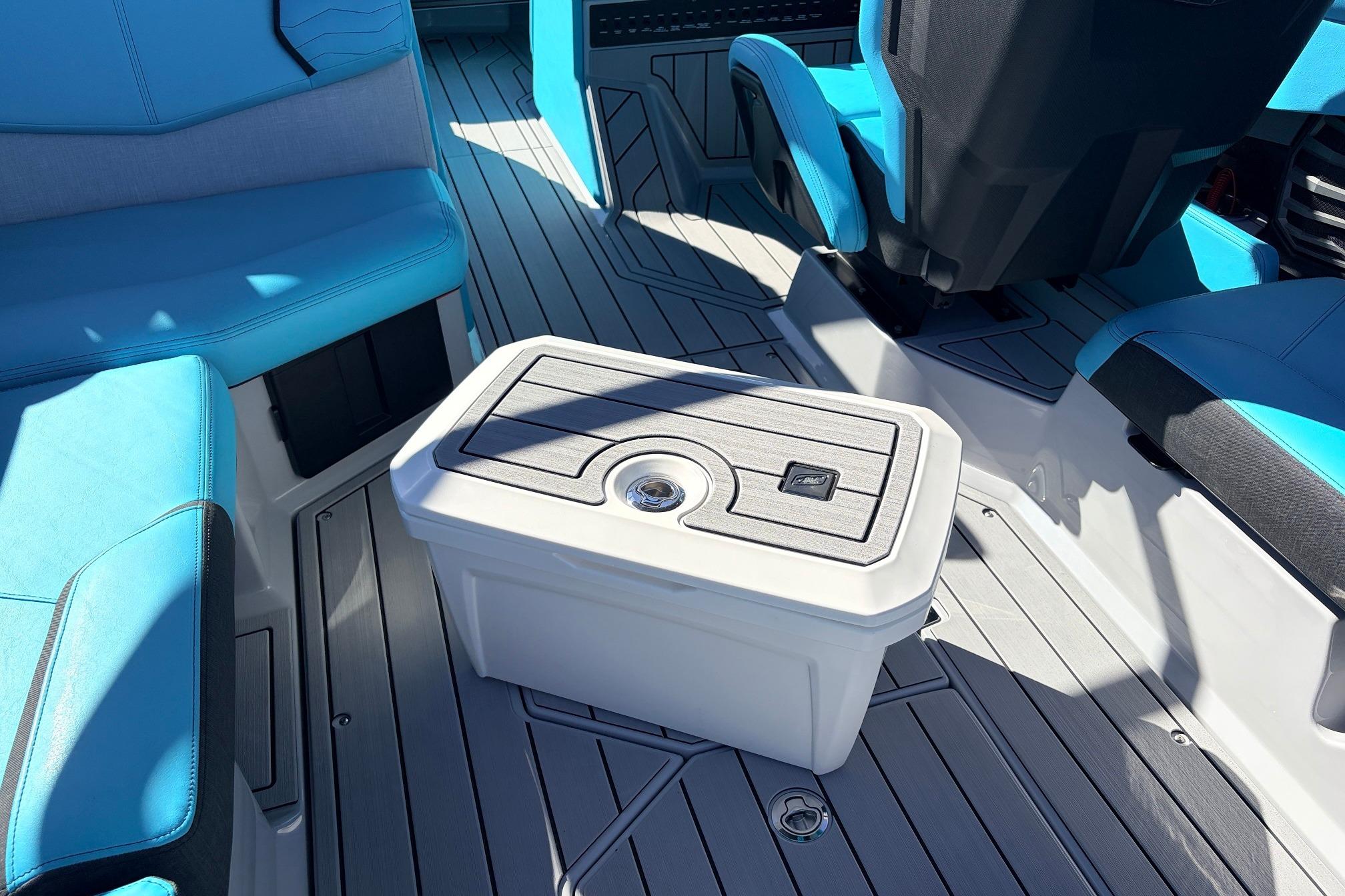 Interior of 2026 Nautique Super Air Nautique G23 with blue seating and storage compartment.