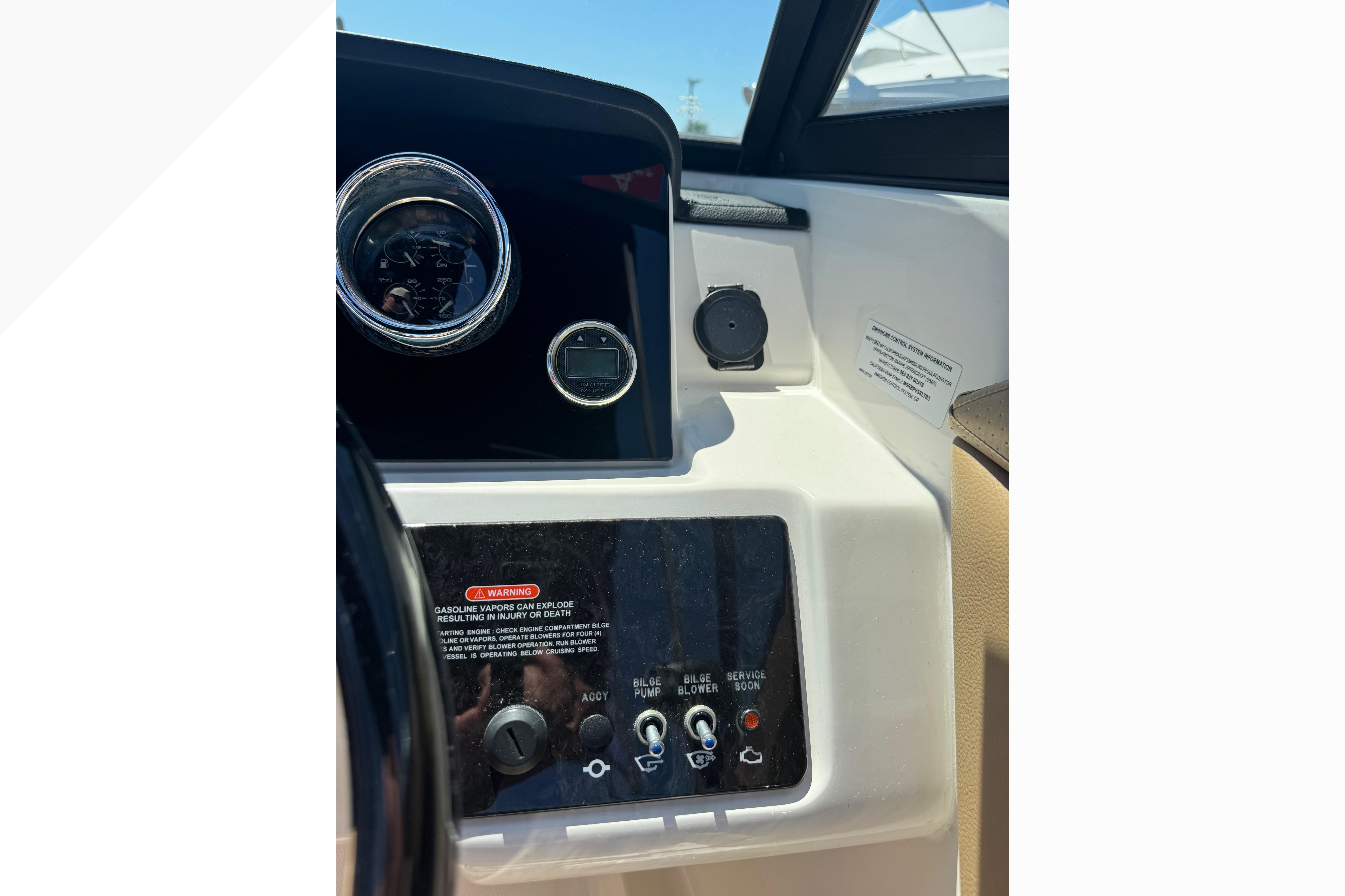 Dashboard controls of a 2021 Sea Ray SPX 190 boat, featuring gauges and switches.