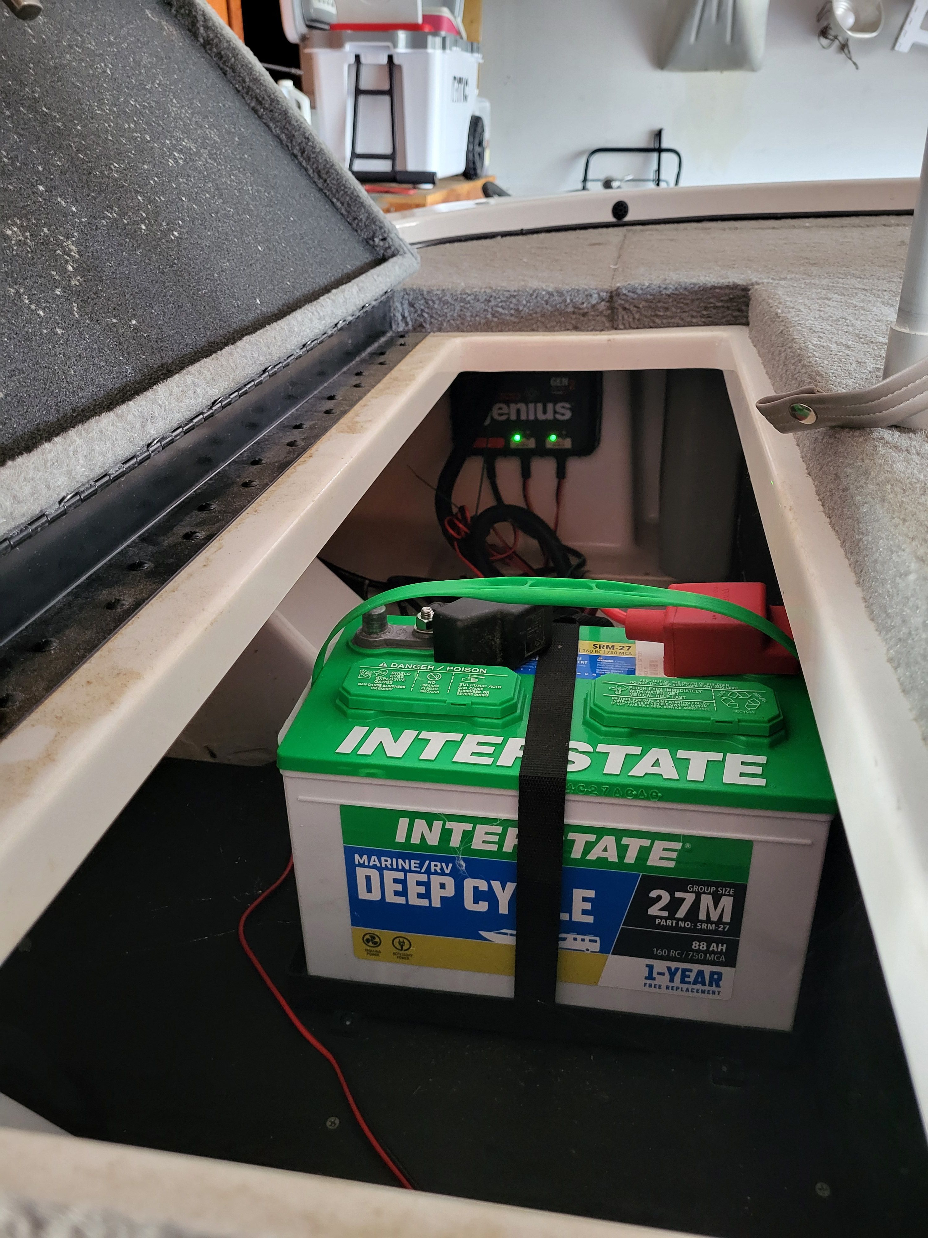 An Interstate deep cycle marine battery is installed in a boat.