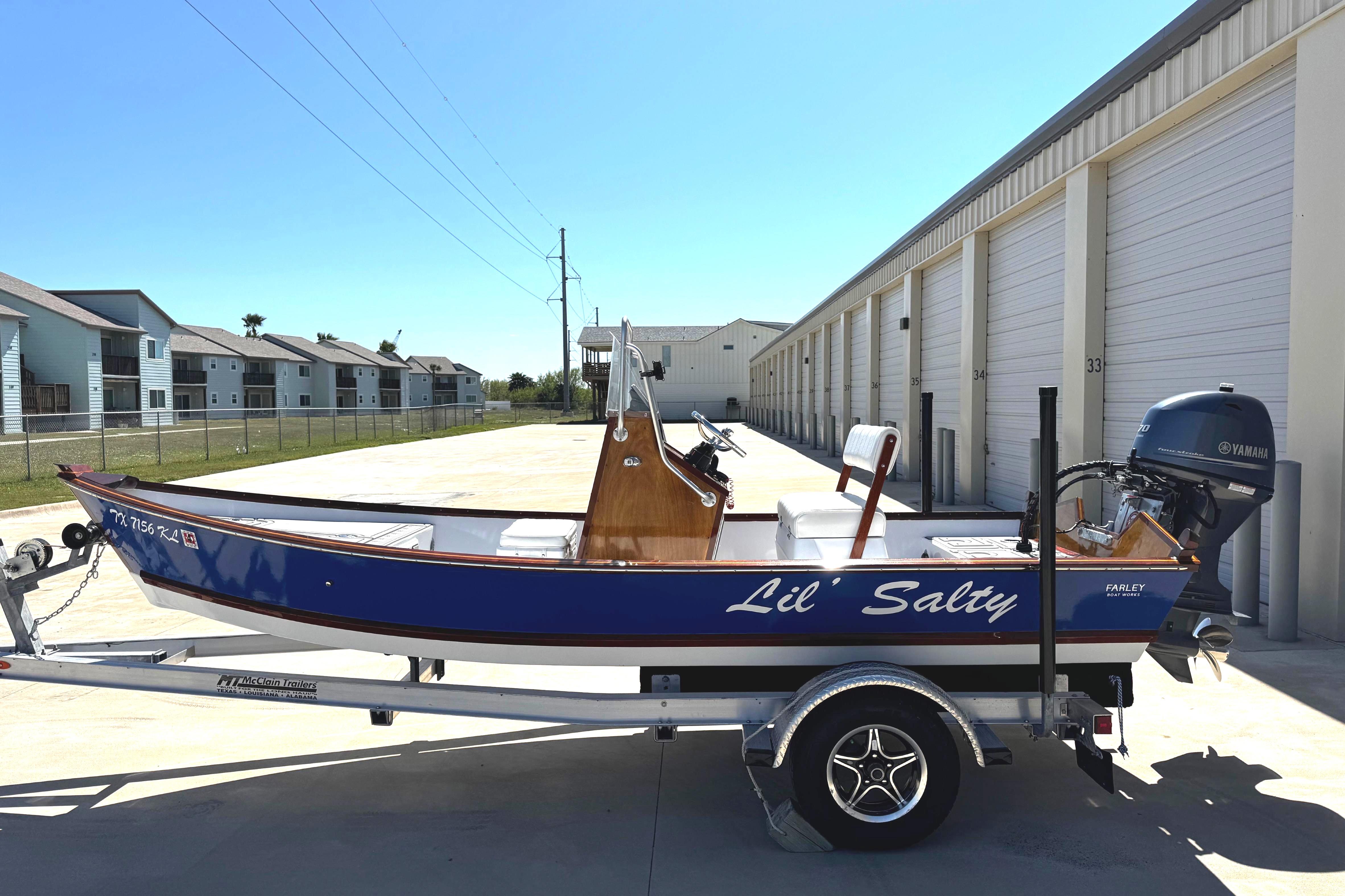 2022 Farley Port A Skiff "Lil' Salty" on trailer, parked near storage units.