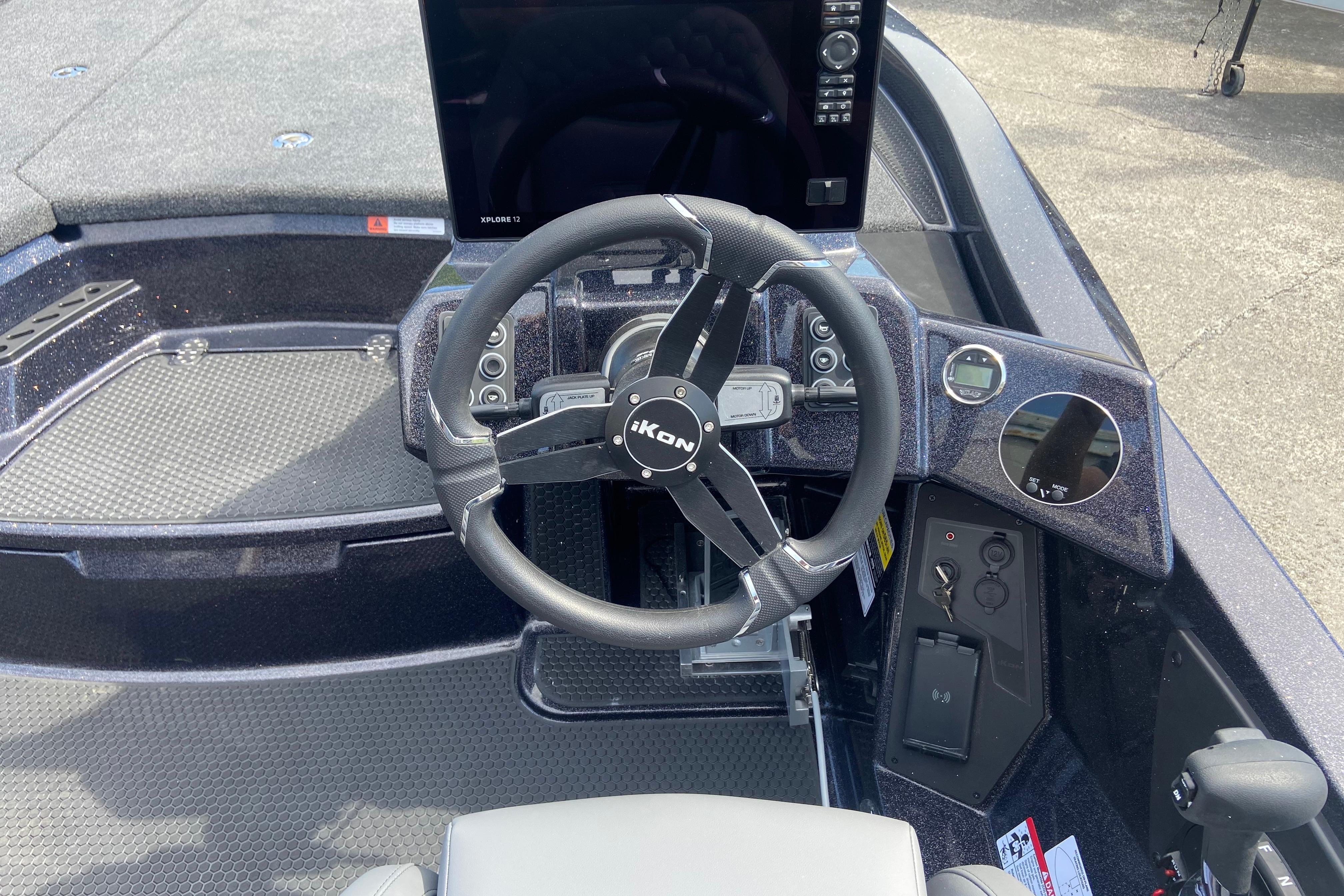 Steering wheel and dashboard of 2026 iKon VLX 20 boat, featuring modern controls.