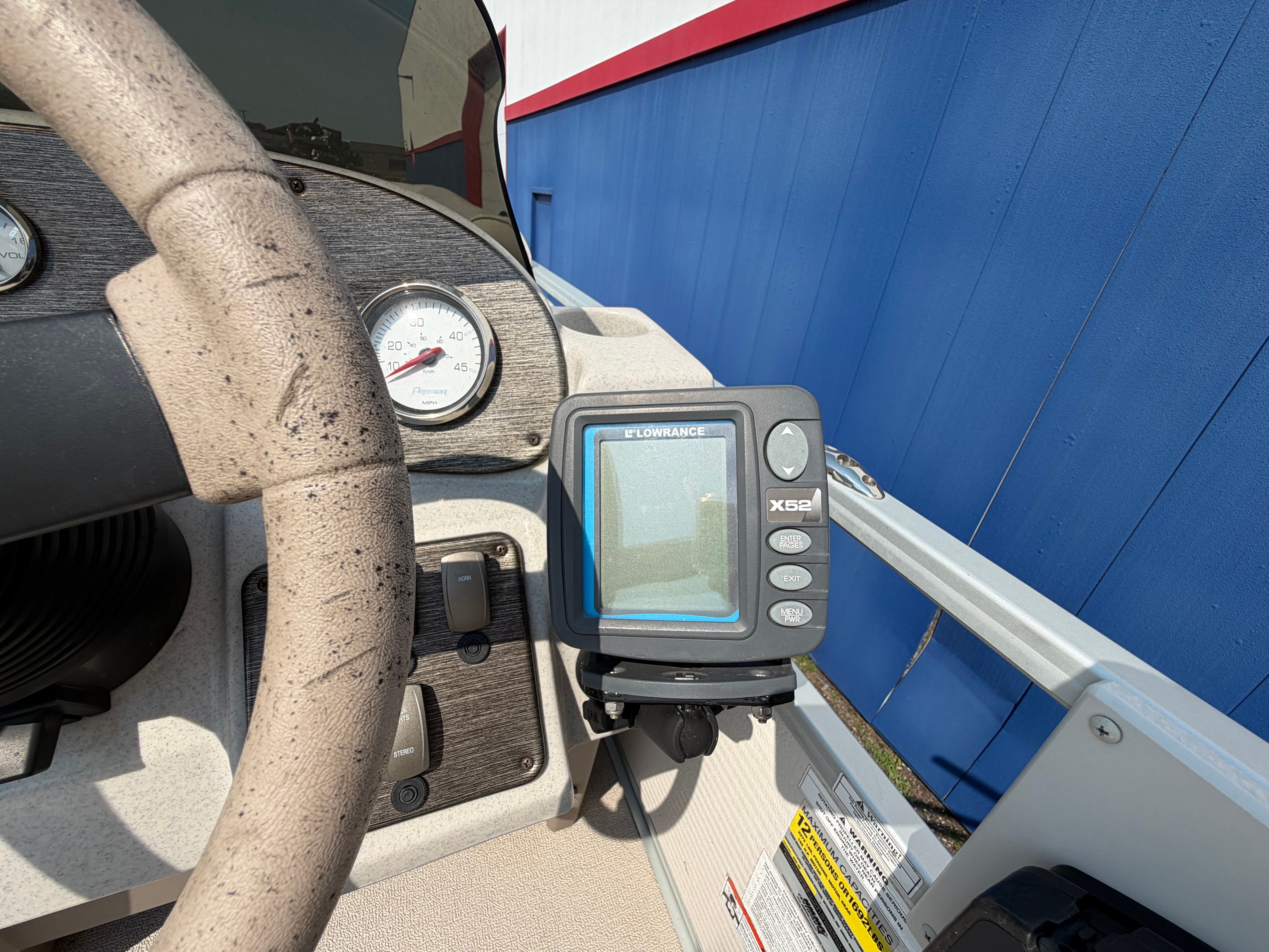 Dashboard of a 2007 Premier 225 Sunsation boat with a Lowrance X52 device.