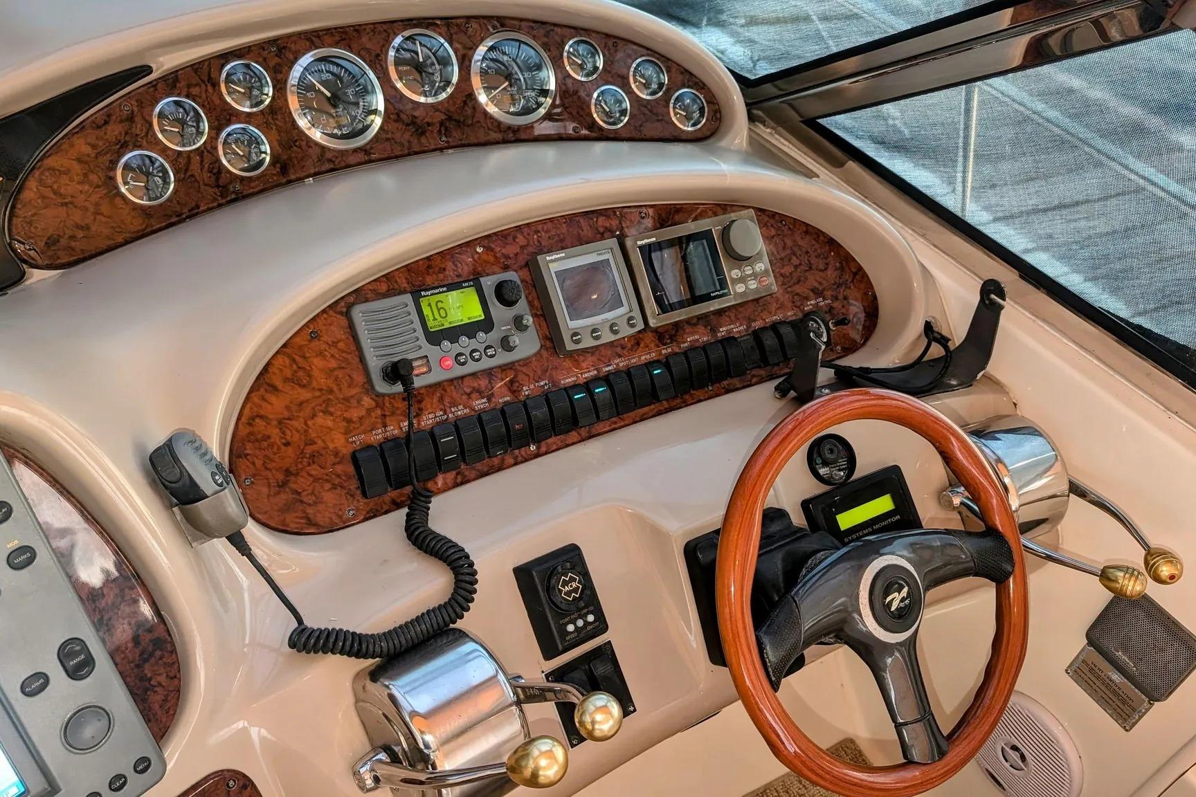 Helm of 2000 Sea Ray 380 Sundancer with wood accents and modern controls.