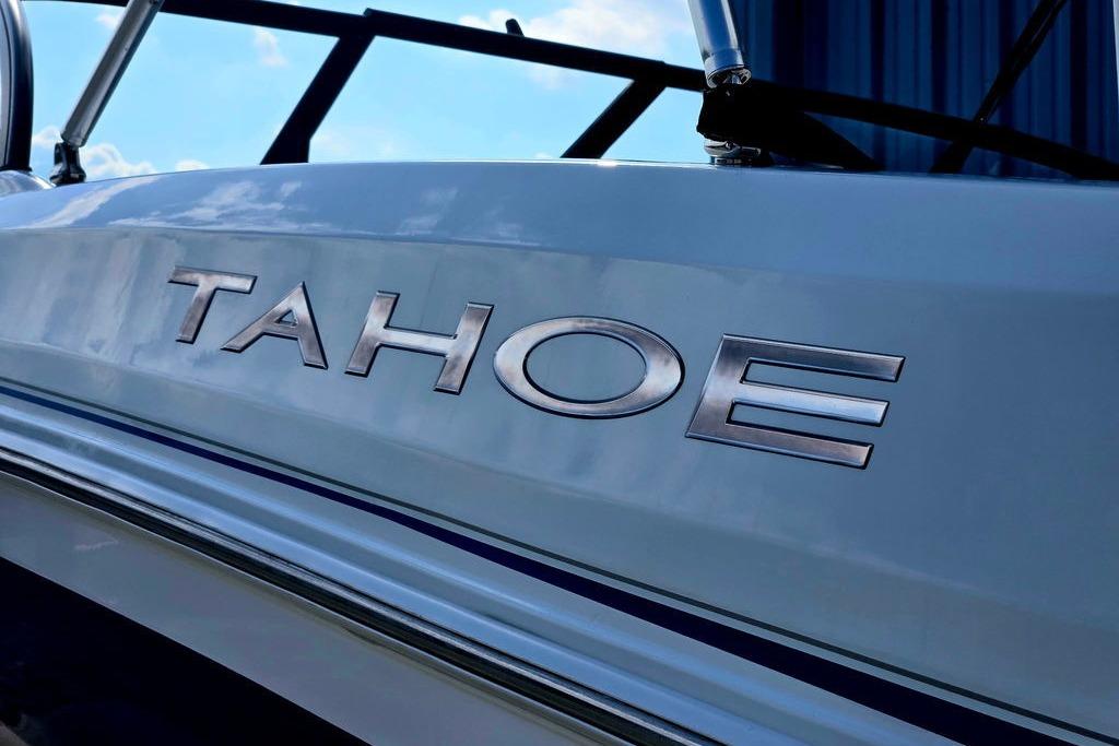 2018 Tahoe 450 TS boat with metallic logo detail under blue sky.