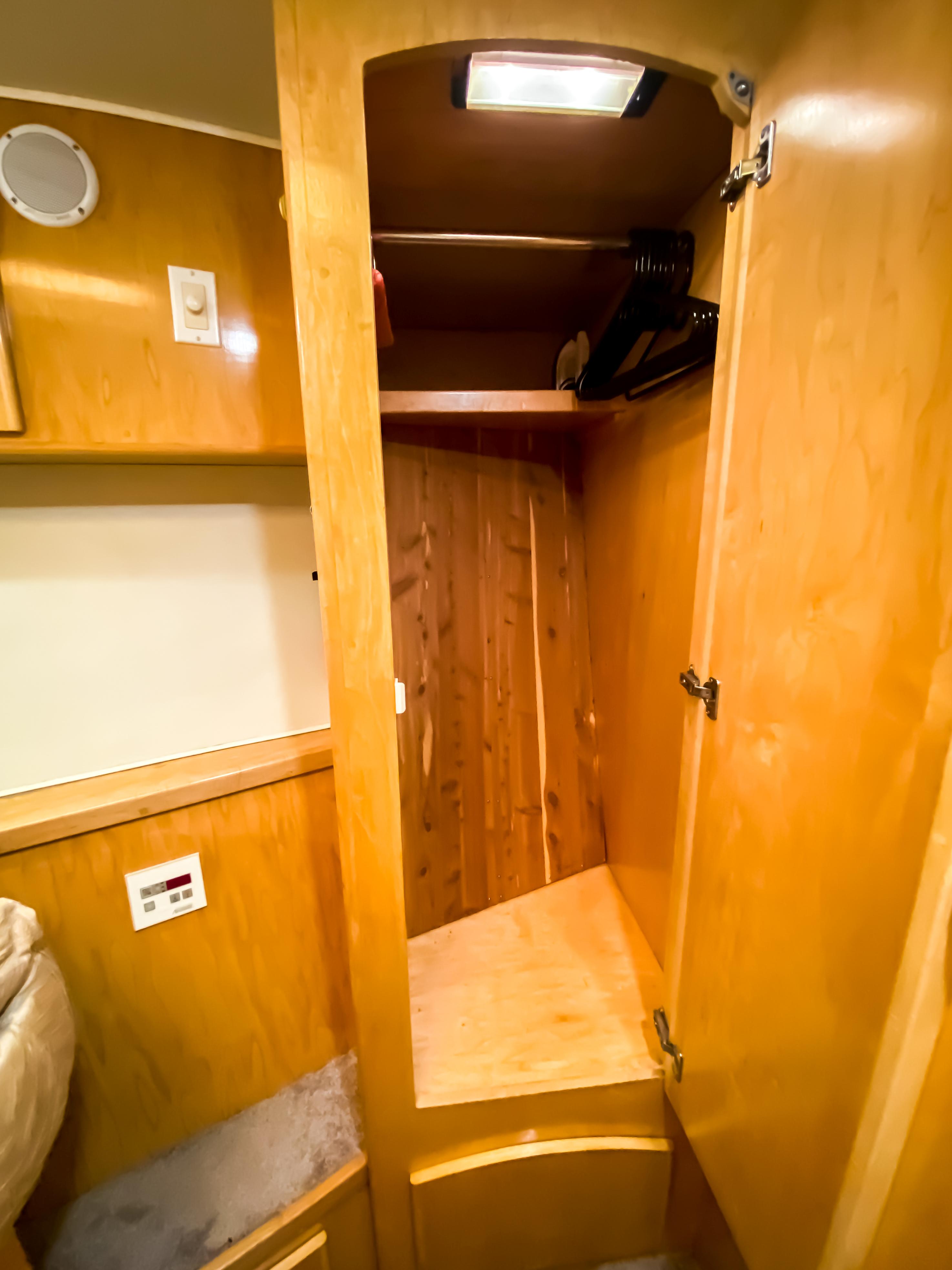 Wooden closet interior in 1999 Navigator 5800 model, featuring shelves and hangers.