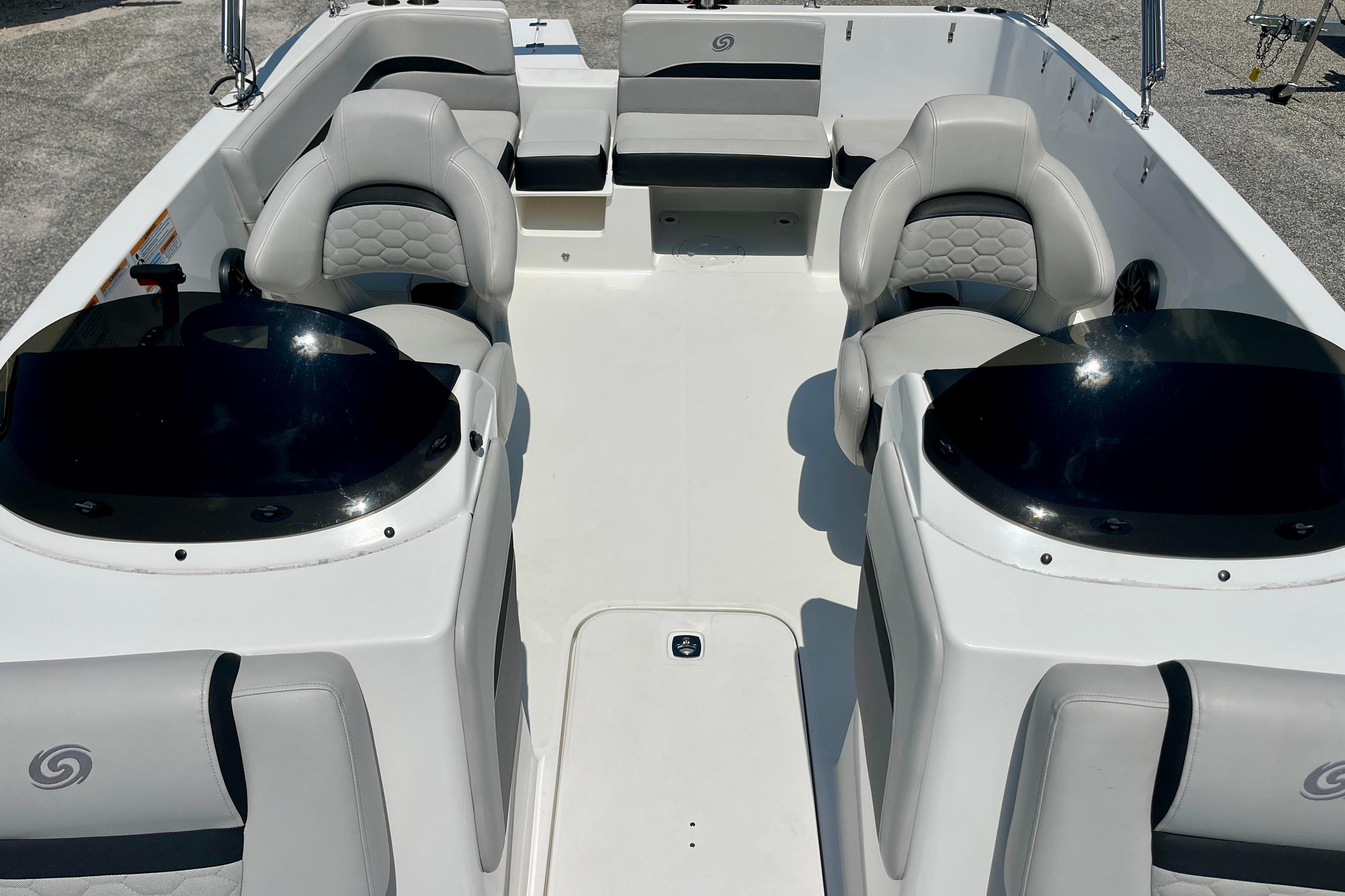2024 Hurricane Sundeck Sport 218 OB interior with seating and helm, showcasing modern design.