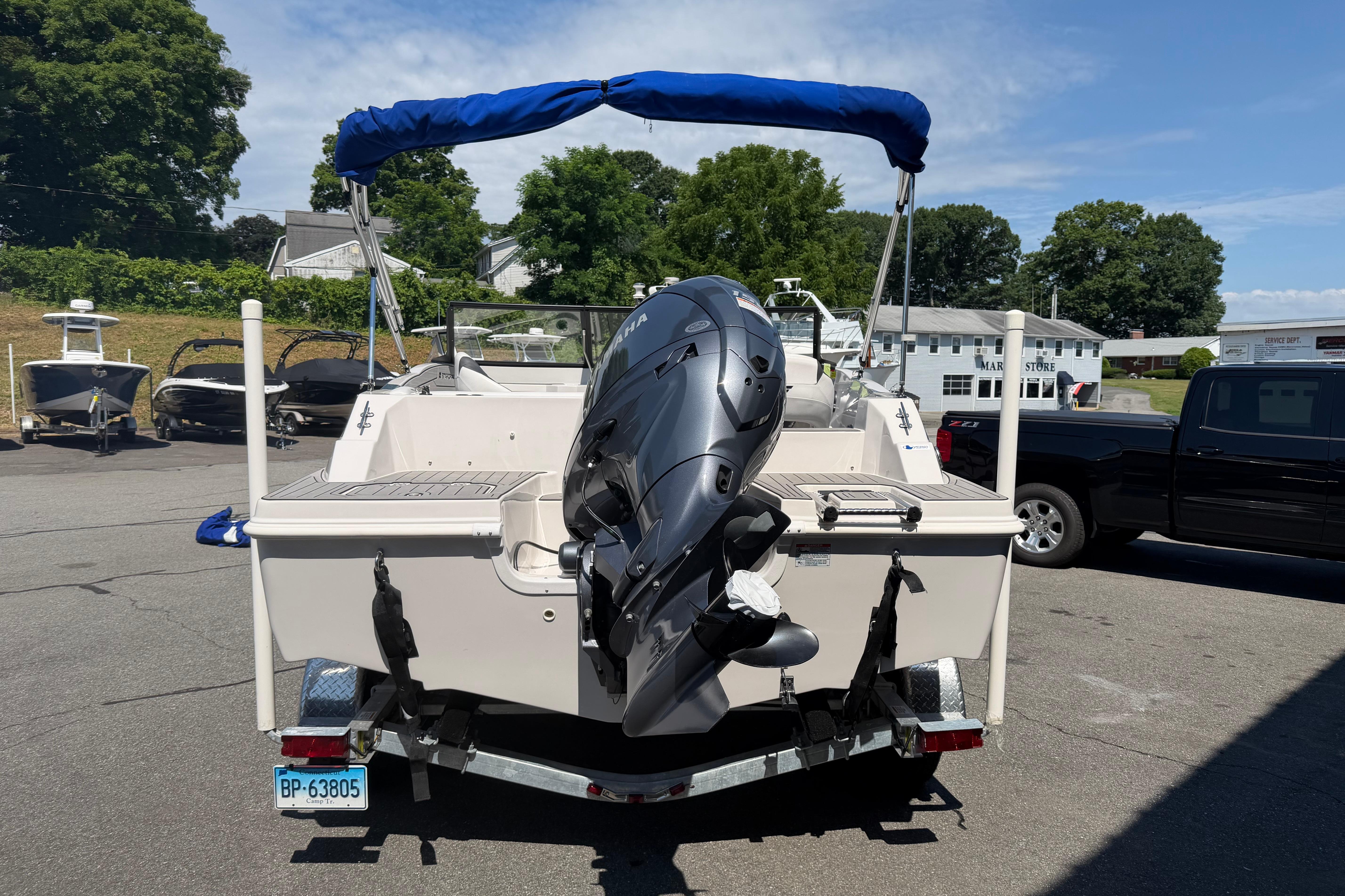 2025 Starcraft SVX 190 OB boat with outboard motor on trailer, parked outdoors.