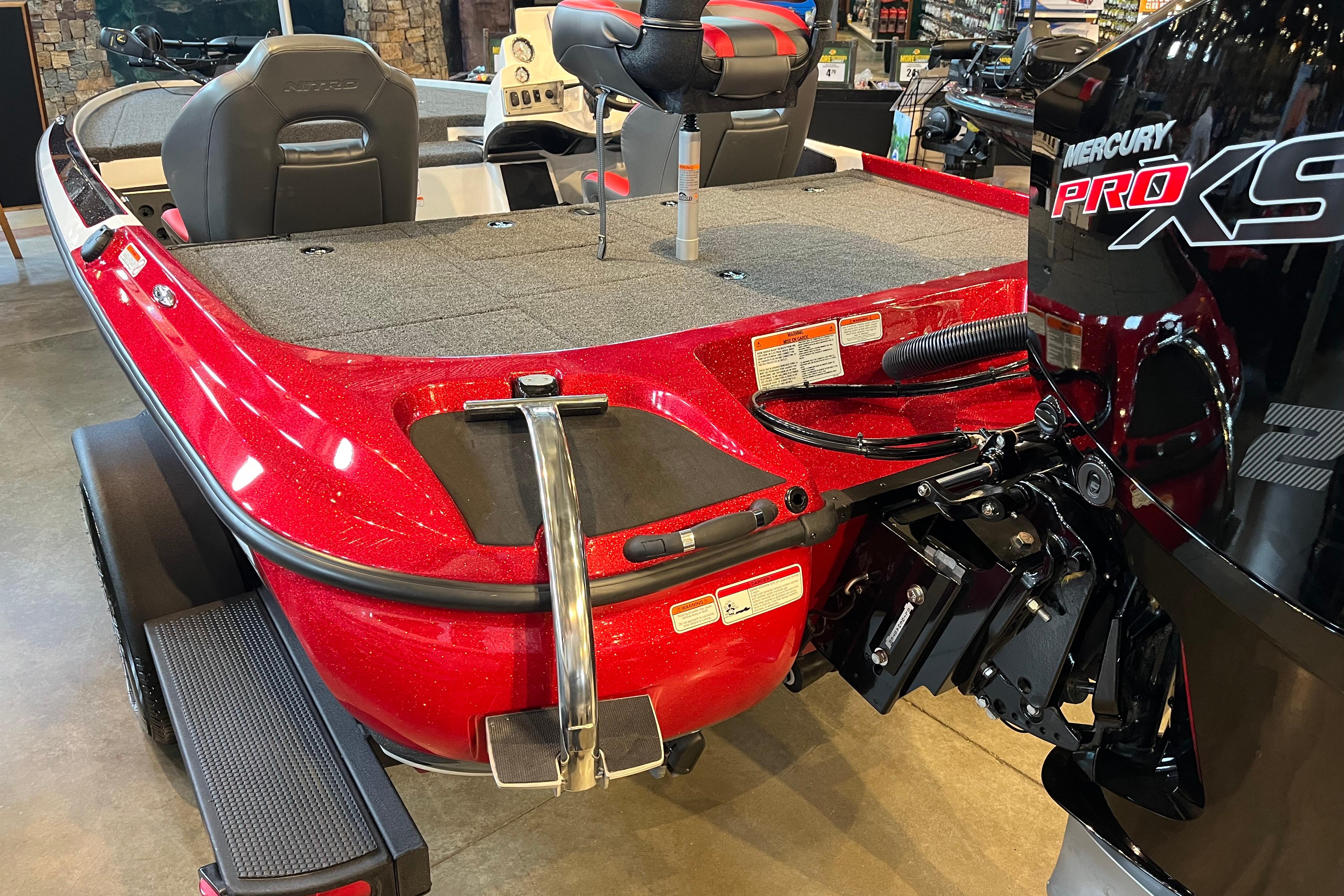 Red 2025 Nitro Z19 boat with Mercury Pro XS engine, displayed indoors.