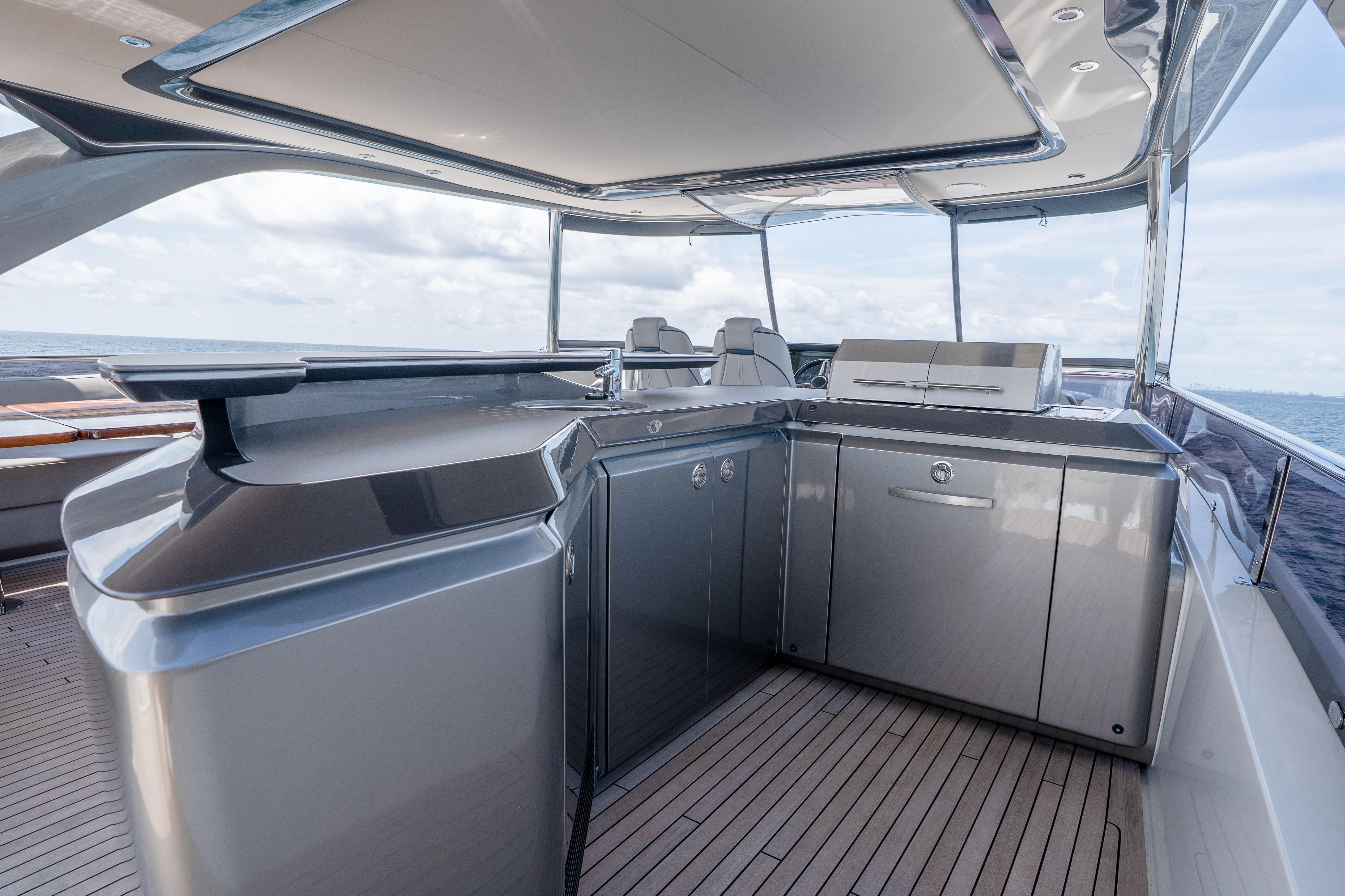 Luxurious 2020 Princess Y85 yacht deck with modern outdoor kitchen and ocean view.