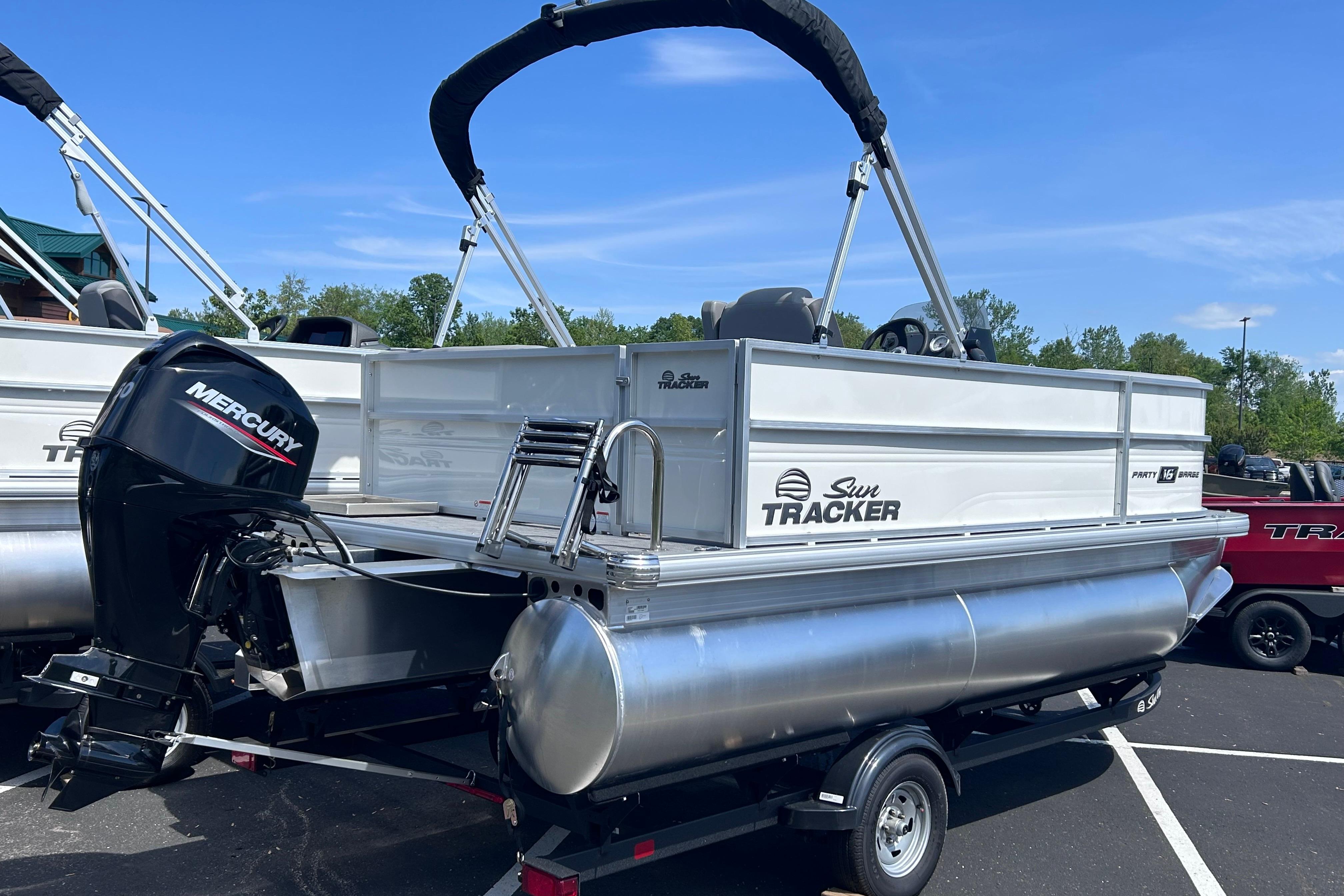 2026 Sun Tracker Party Barge 16 DLX pontoon boat with Mercury outboard motor.