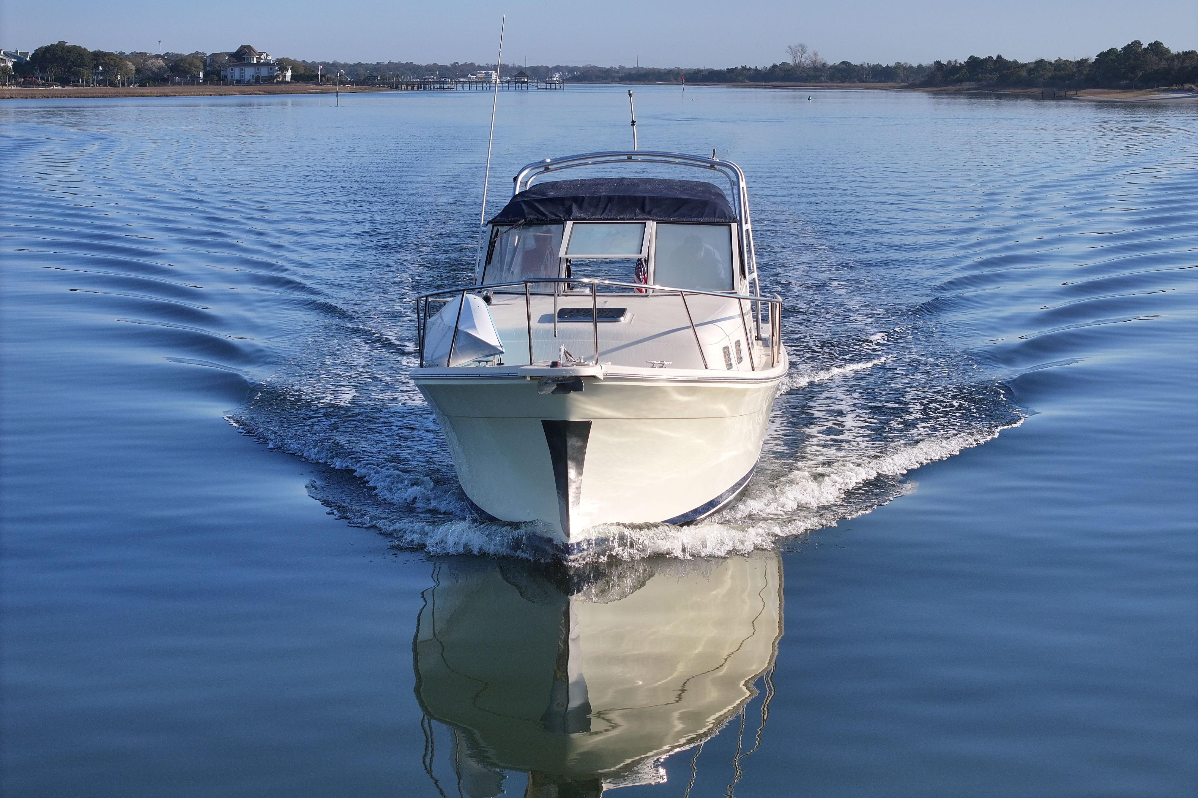 2004 Mainship Pilot 30 Rum Runner cruising on calm water.
