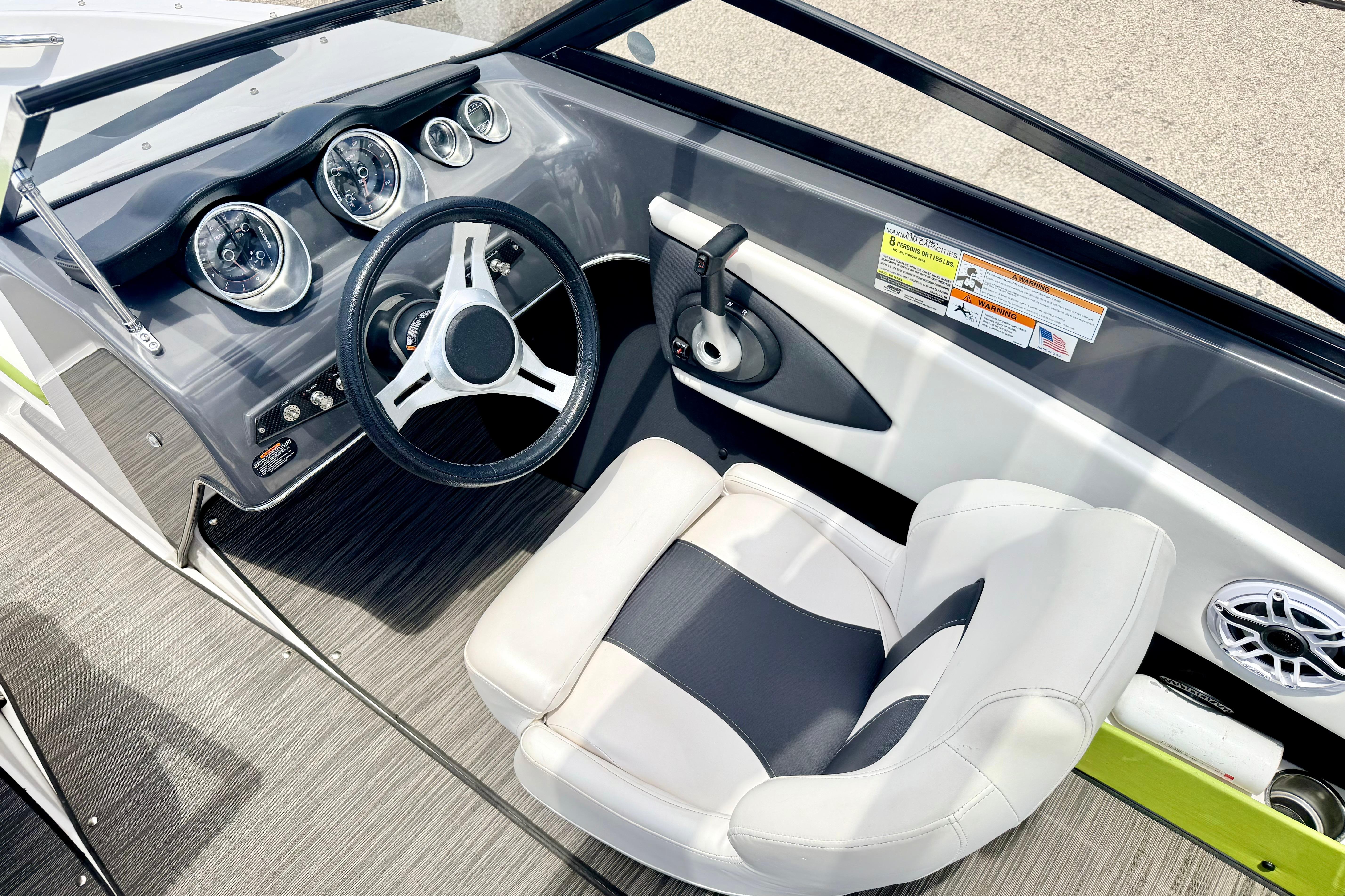 2018 Glastron GT 185 boat interior with steering wheel and dashboard controls.