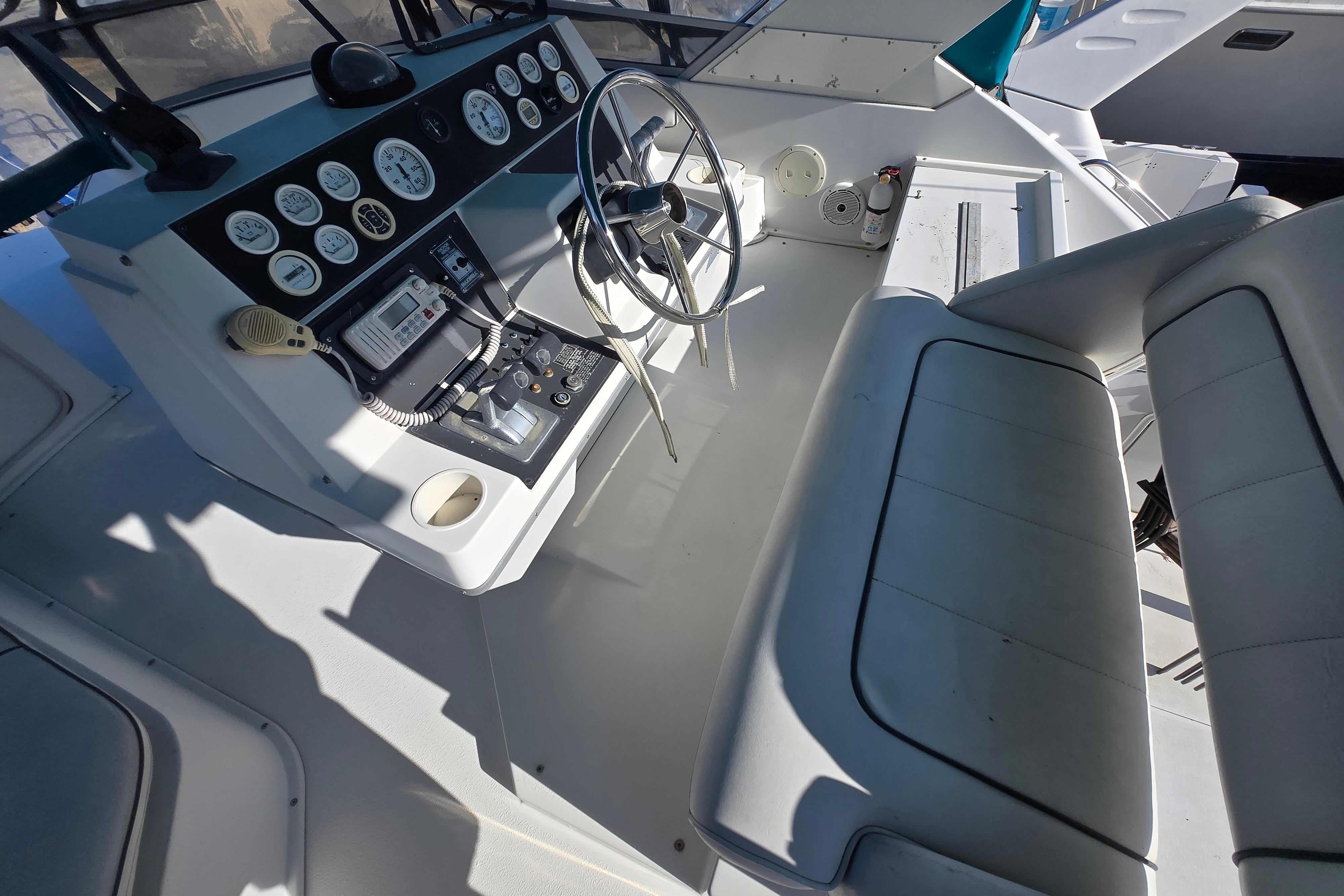 Cockpit of 1994 Carver 380 Santego yacht with steering wheel and control panel.
