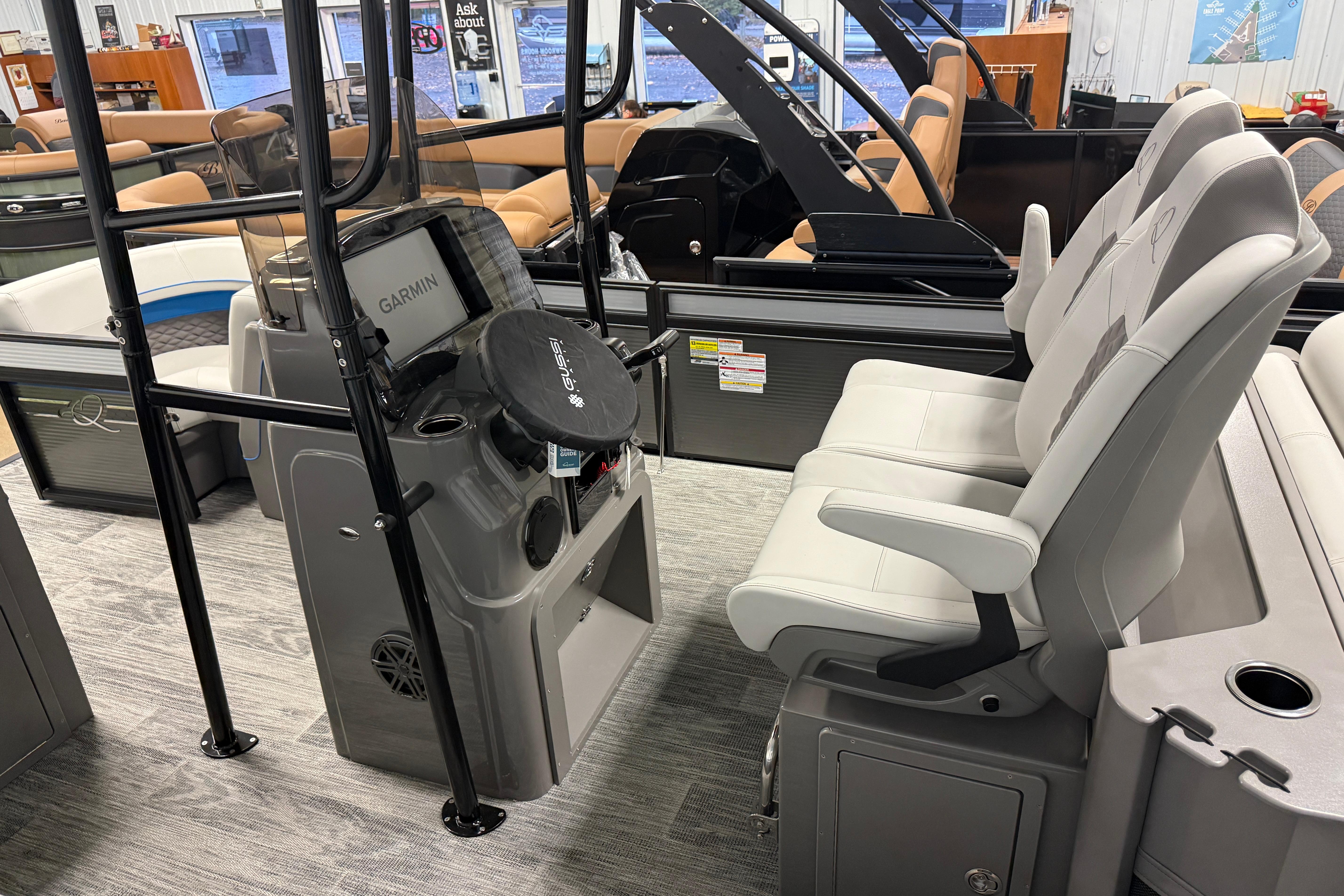 Interior of 2026 Qwest M-Class 22 Pro Sport boat with modern seating and Garmin equipment.