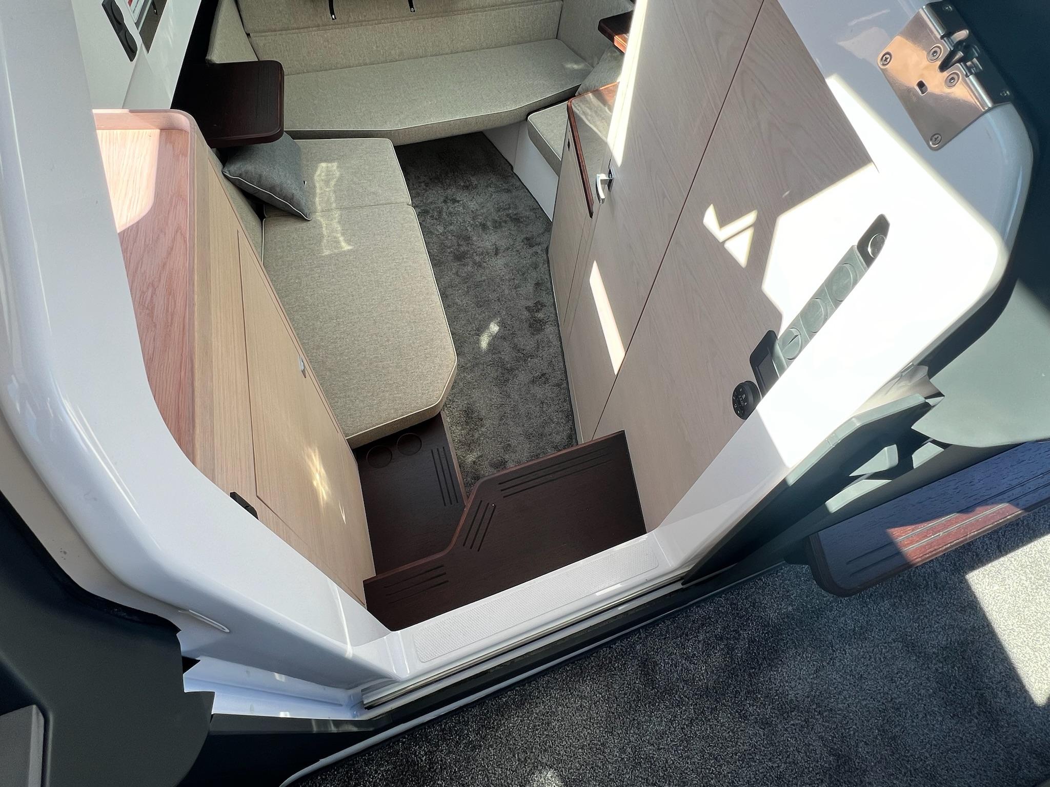 Interior of 2024 Axopar 45 XC Cross Cabin, featuring modern seating and sleek design.