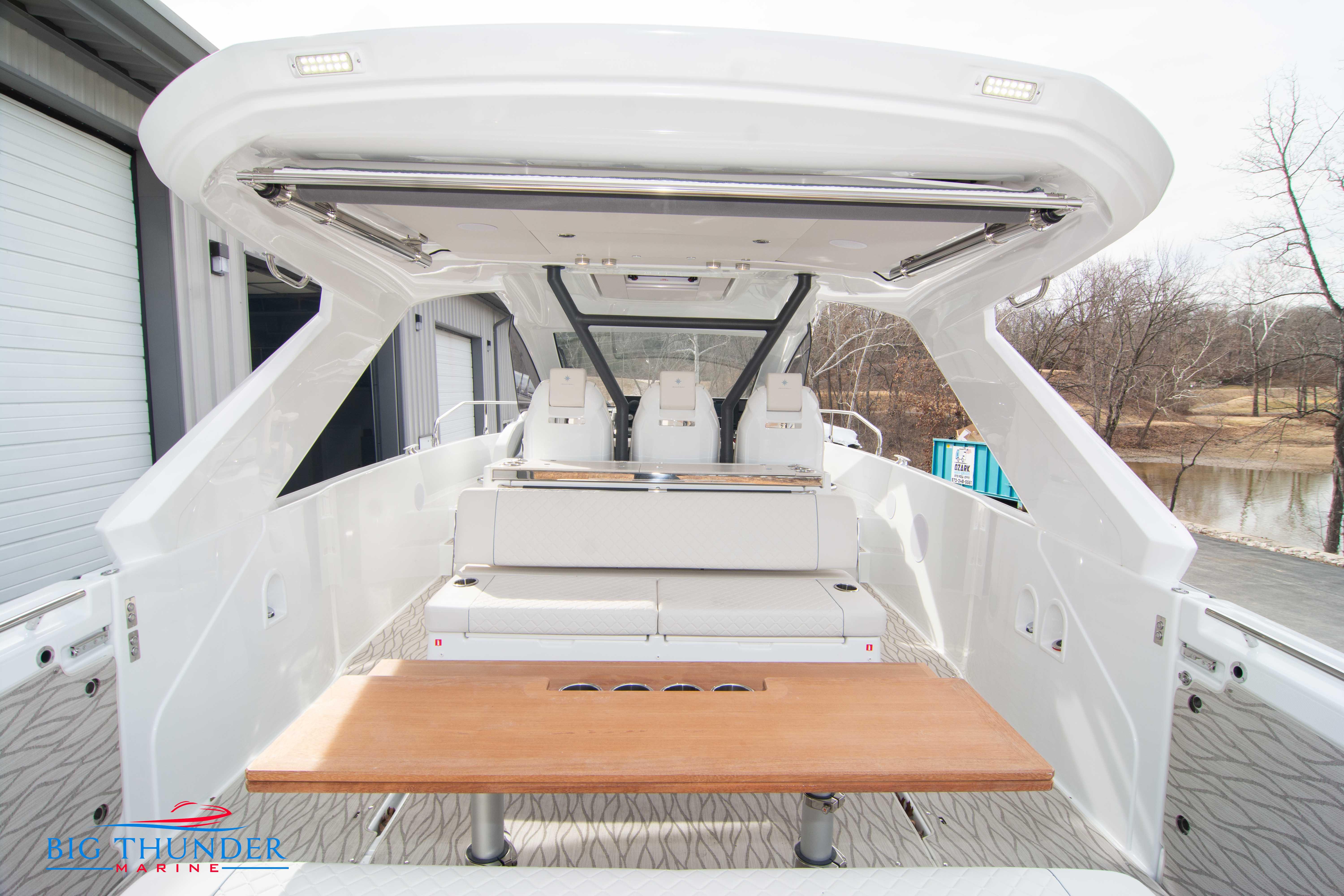 2024 Jeanneau DB/37 OB boat interior with seating and table.