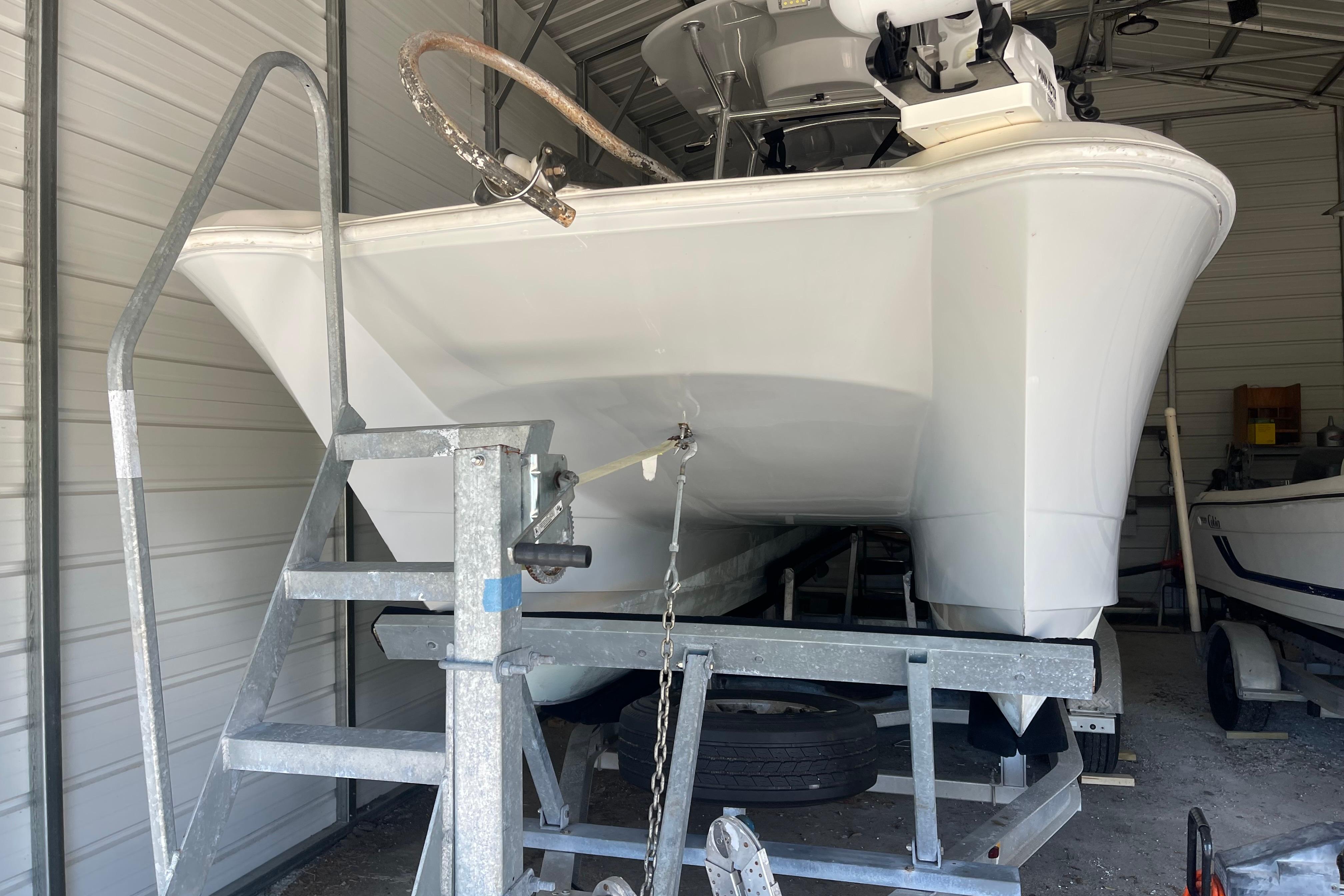 2020 Twin Vee 230 JP CC boat on trailer in storage facility.