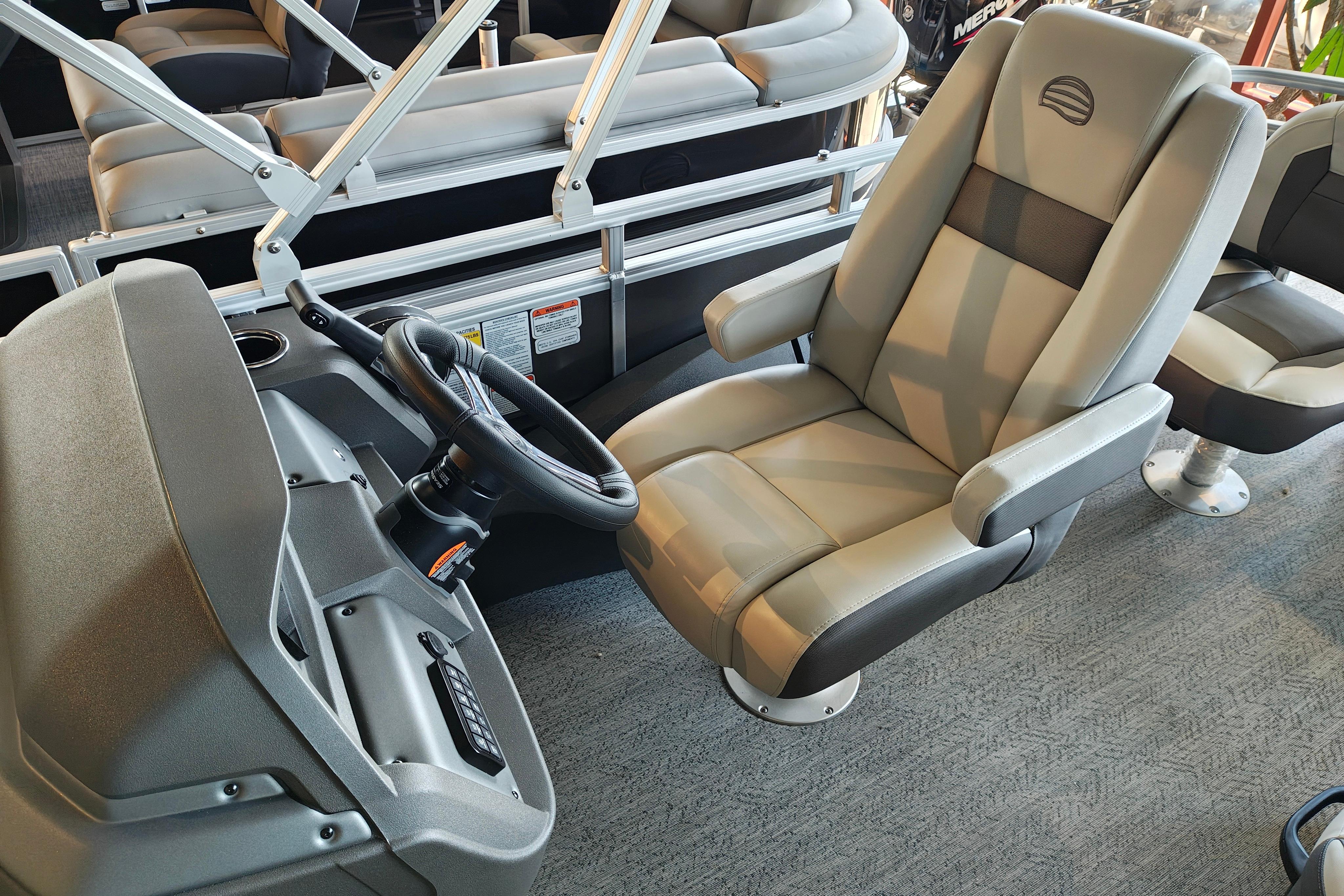 Captain's chair and helm of 2026 Sun Tracker Fishin' Barge 22 XP3 pontoon boat.